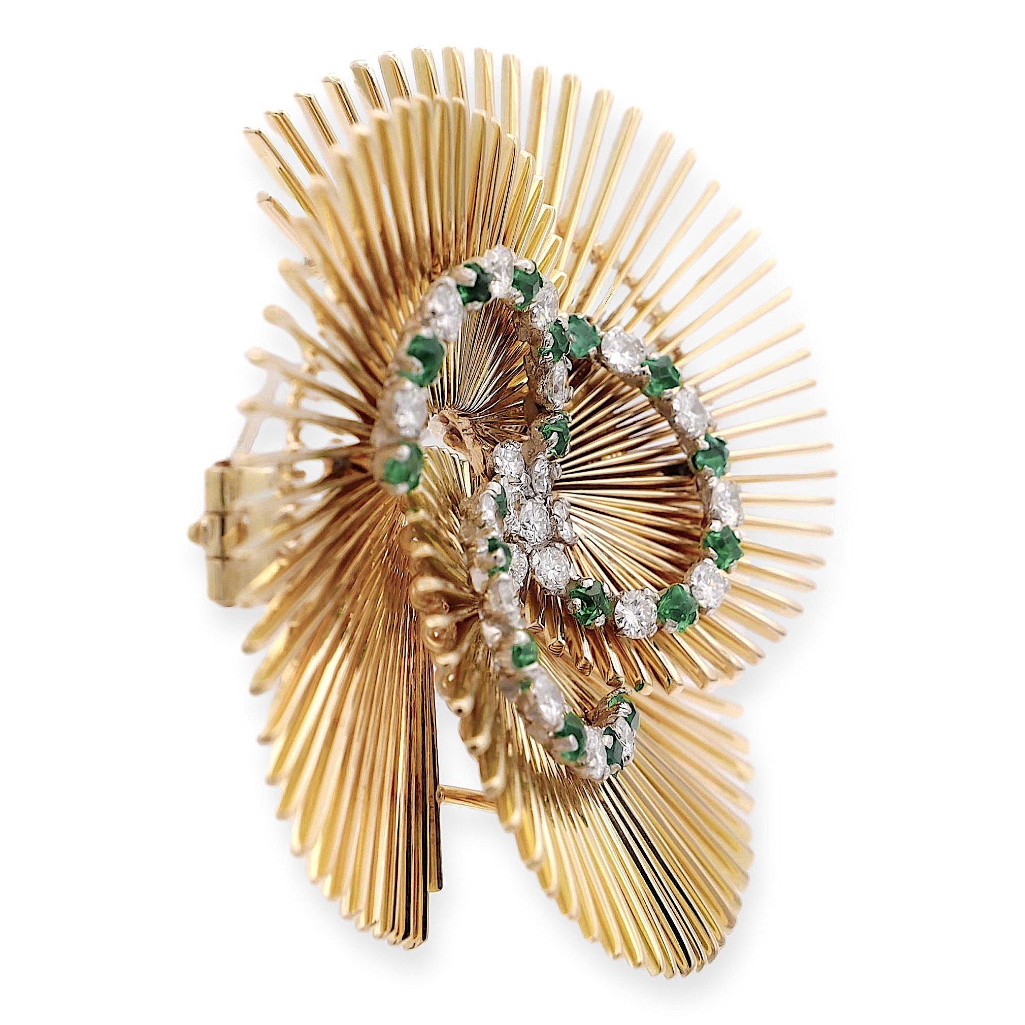 Vintage Brooch finely crafted in 14 karat yellow gold with a cluster of diamonds in the center complemented by a swirl design with interlocking round brilliant cut diamonds weighing 1 carat total weight ranging in G-H color, VS clarity and square