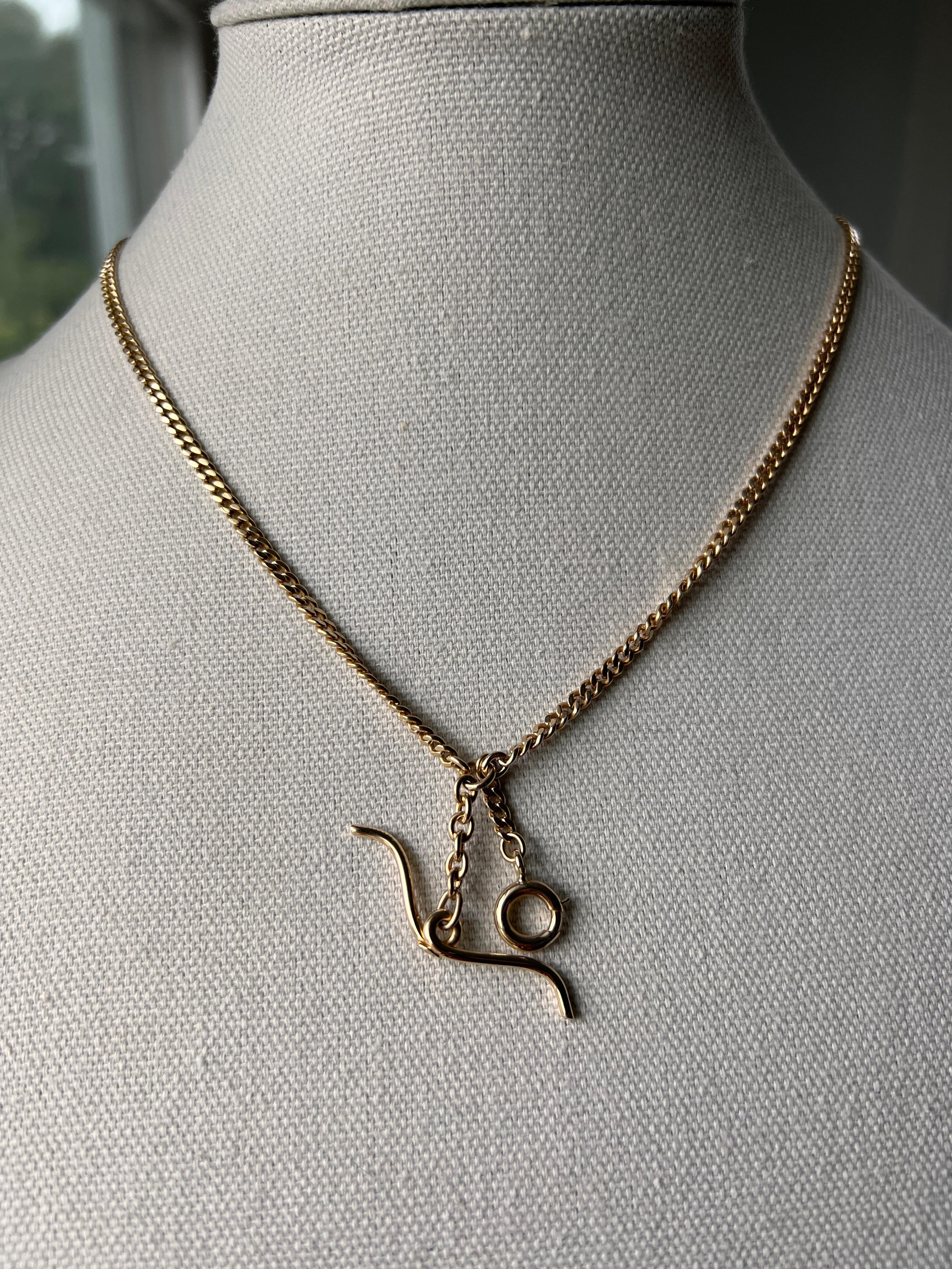 One vintage 14 karat yellow gold double pocket watch chain measuring 19 inches in length. This elegant chain is fitted with two spring ring clasps, designed for securing a watch and fob or other accessory. Stamped 