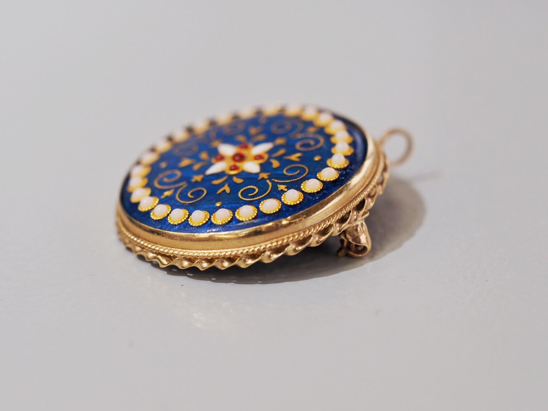 Exquisite Enamel design giving the appearance of pearls on the outer edge and beautiful details in the center that give the appearance of bright red rubies. The details on this pendant brooch are  truly amazing and vibrant. The versatility adds a