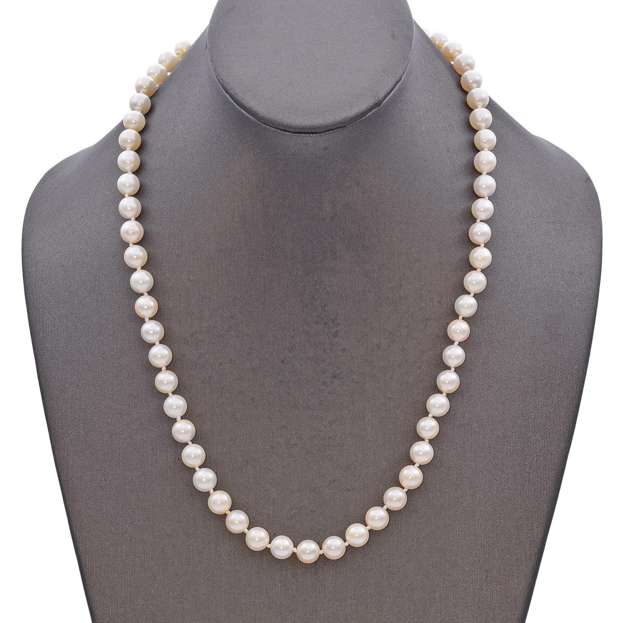 A classic pearl necklace crafted in 14k gold, this elegant piece features a strand of lustrous white pearls. Each pearl is meticulously matched in size and color, creating a seamless and timeless design. The necklace is secured with a gold clasp,