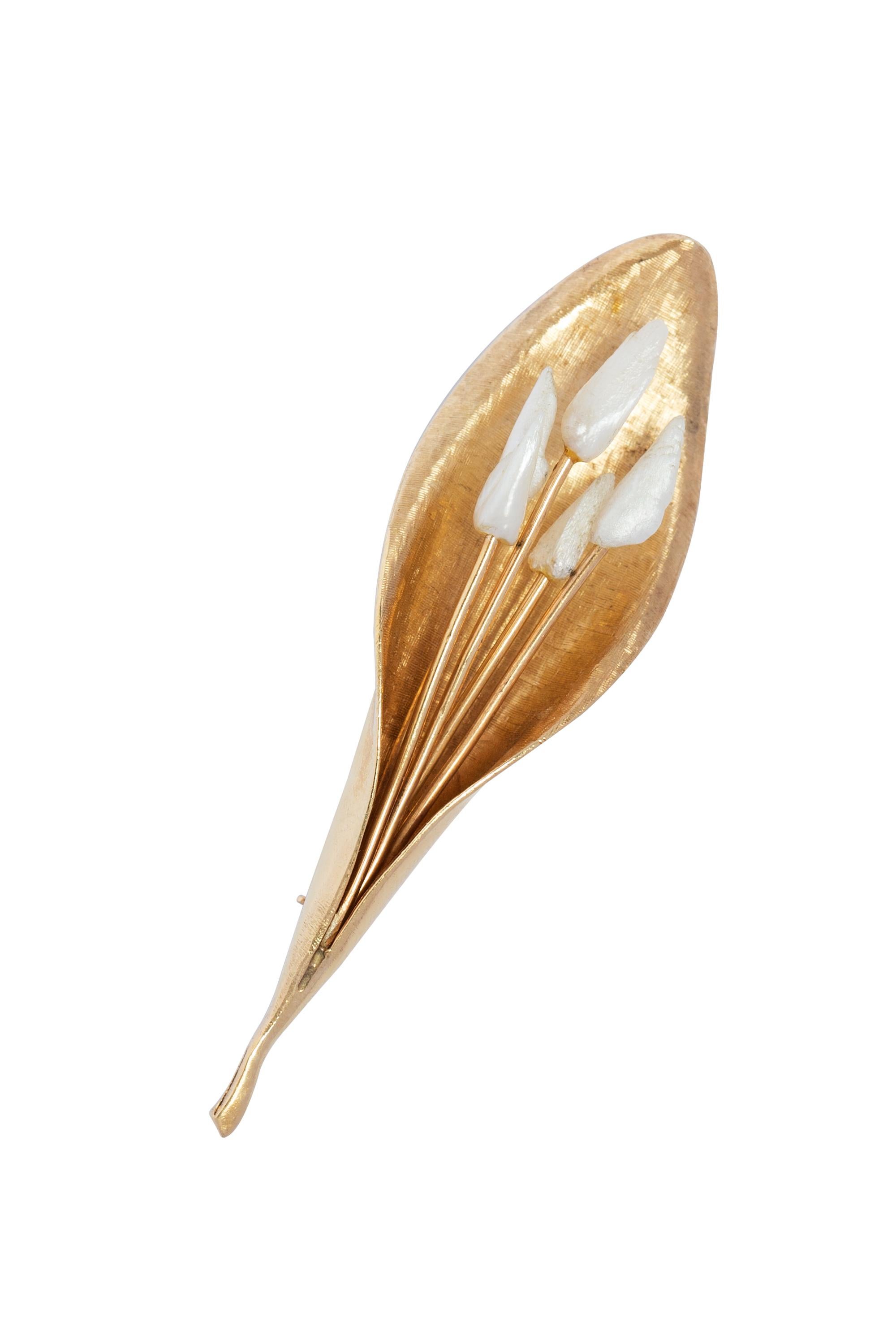 Vintage leaf / flower brooch with fine etching texture. At center is carved baroque pearls with gold stems. The brooch measures 2.75 inches long. 