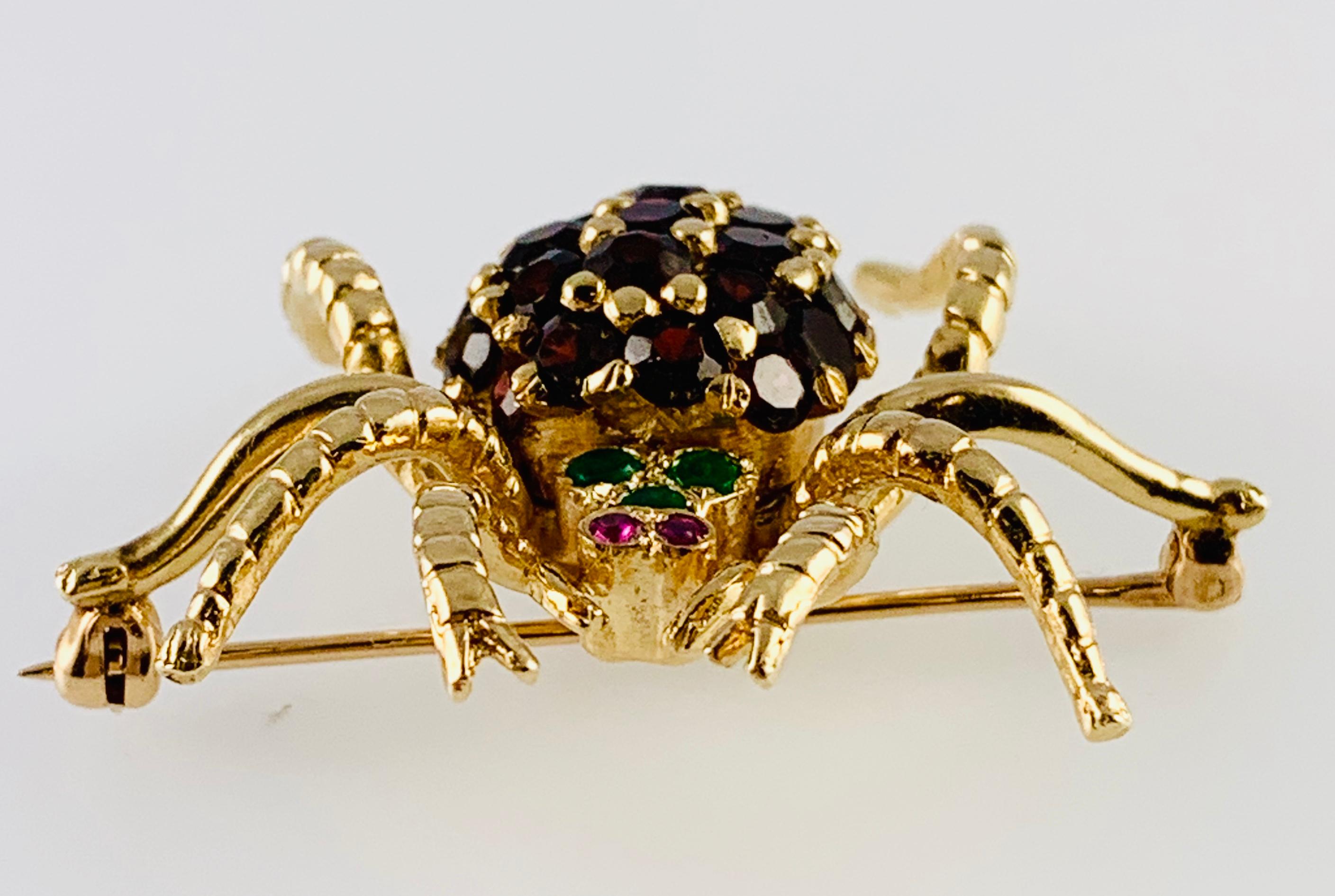 Beautiful & Whimsical Vintage Spider Brooch / Pin! Made in 14K yellow Gold with Garnets for the body, Ruby eyes and three Emeralds as well! It measures 1.25 inches by 1.5 inches and weighs 11.4 grams.
