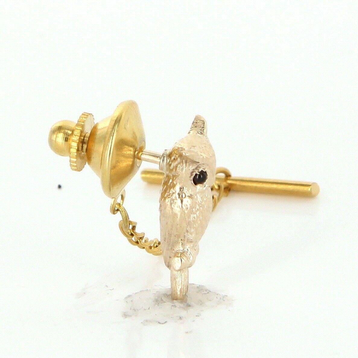 Offered for sale is a truly superb vintage tie tac pin (circa 1950s to 1960s), crafted beautifully in 14 karat yellow gold. 

A finely detailed owl bird is finished with an estimated .05 carat cabochon cut garnets that are set as eyes. 

Vintage tie
