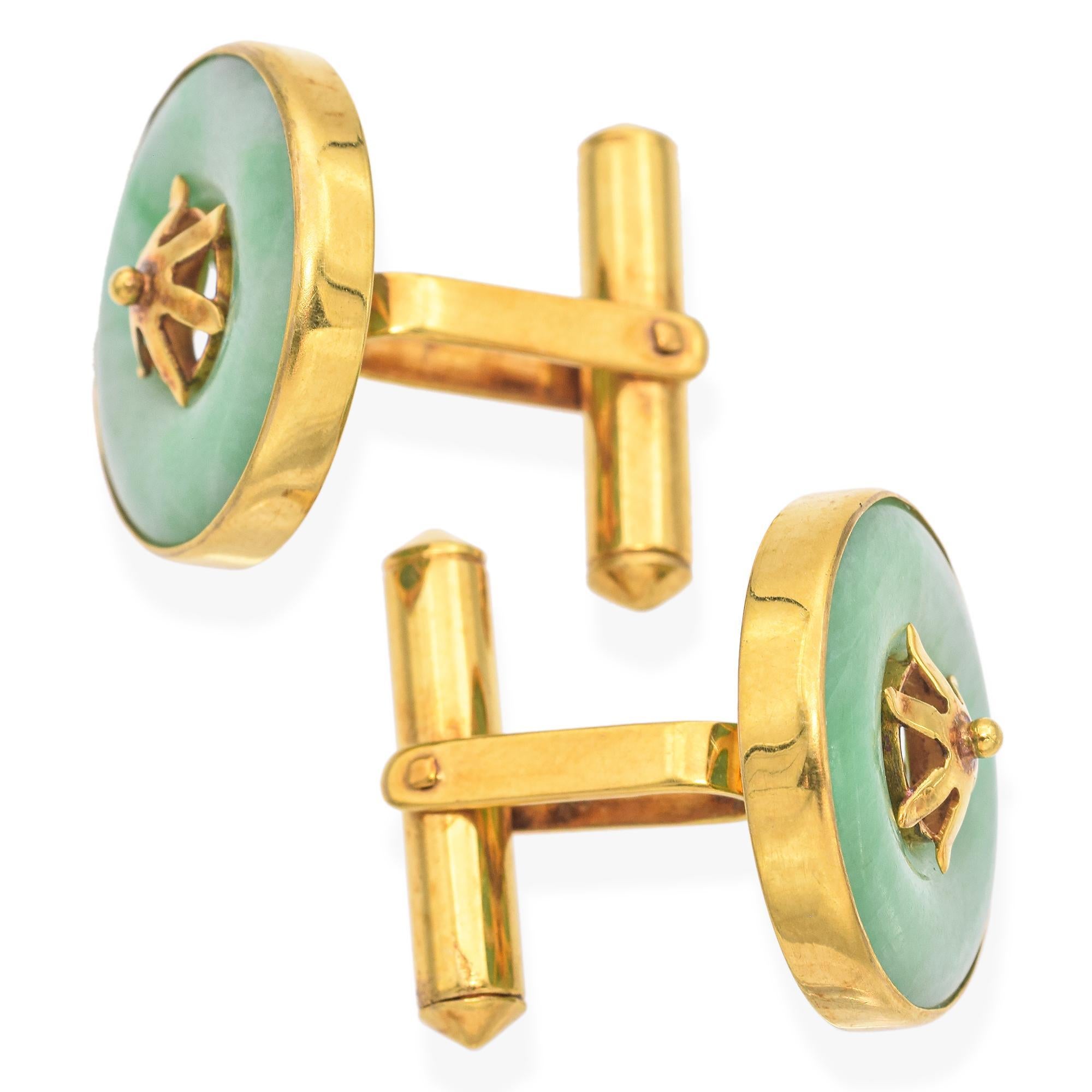 A pair of 14K yellow gold cufflinks featuring round green jade centers.
Each cufflink is adorned with a gold star-shaped embellishment.

Weight: 9.1 Grams
Stone: Jade
Measurements: Diameter 0.70 Inch
Metal: 14K

ITEM #: BR-1454-111424-16