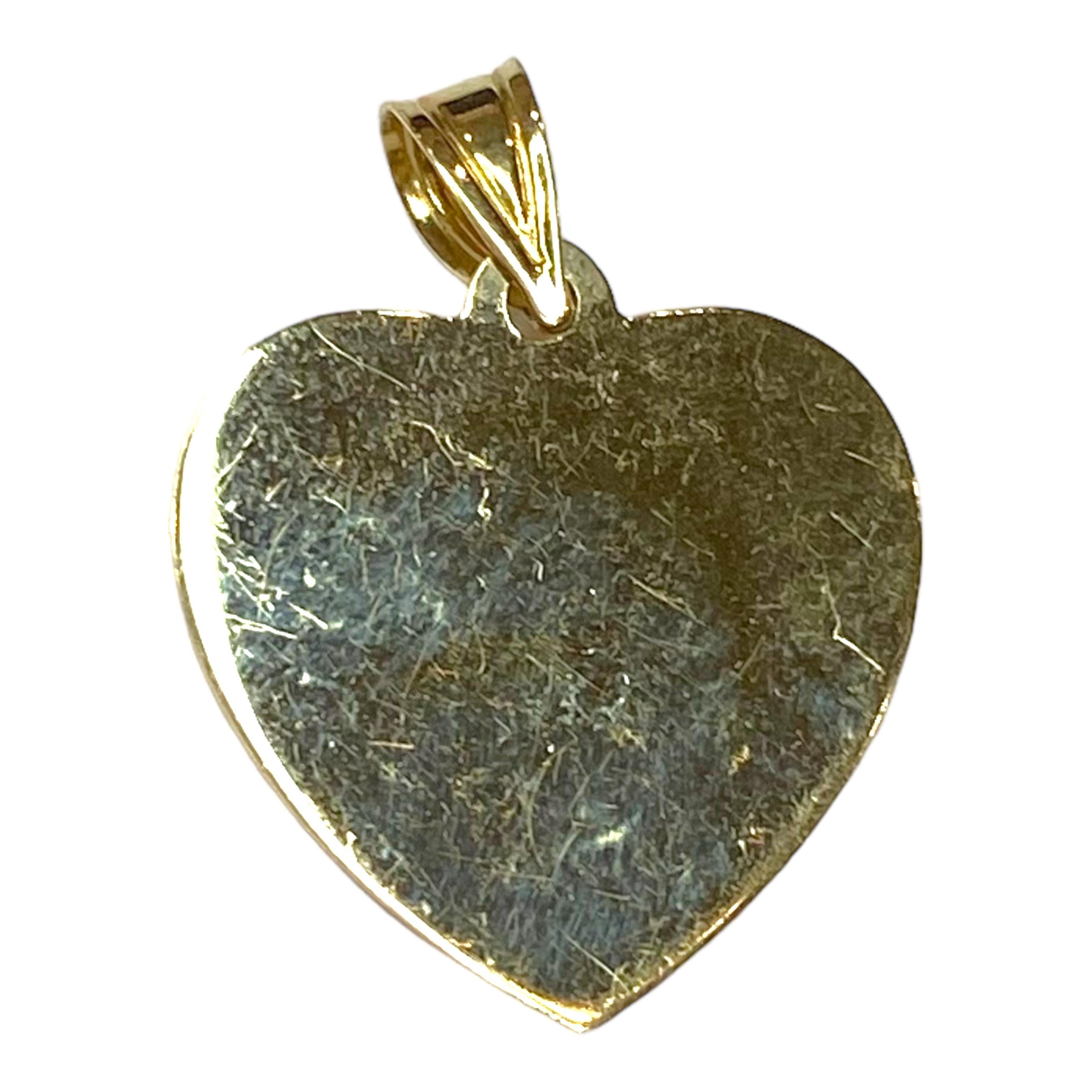 Crafted in 14K yellow gold, the pendant features a hollow heart design with a guardian angel in the center. High polish and matte finish.
Measurements: 25 mm H (including bail) x 19 mm W x 4 mm D
Weight: 1.5 grams
Marked: 14K Ma (Michael Antony)