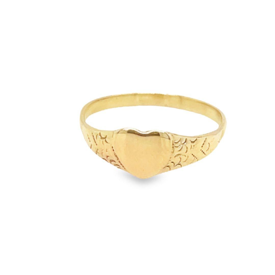 This vintage-inspired piece features a delightful heart shape signet ring with engraved details on the shoulders.

Crafted in 14k Yellow Gold, this beautiful ring showcases a heart surface that can be easily engraved for a personalized touch if
