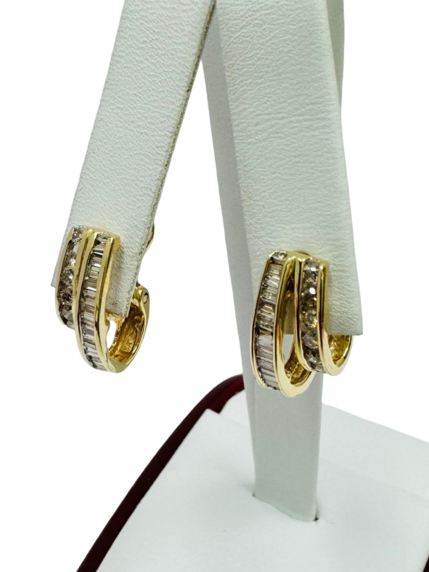 A timeless expression of vintage glamour, these exquisite 14 karat yellow gold hoop earrings feature a refined double-row design, showcasing a seamless blend of baguette-cut and round brilliant-cut natural diamonds. Meticulously set to enhance their