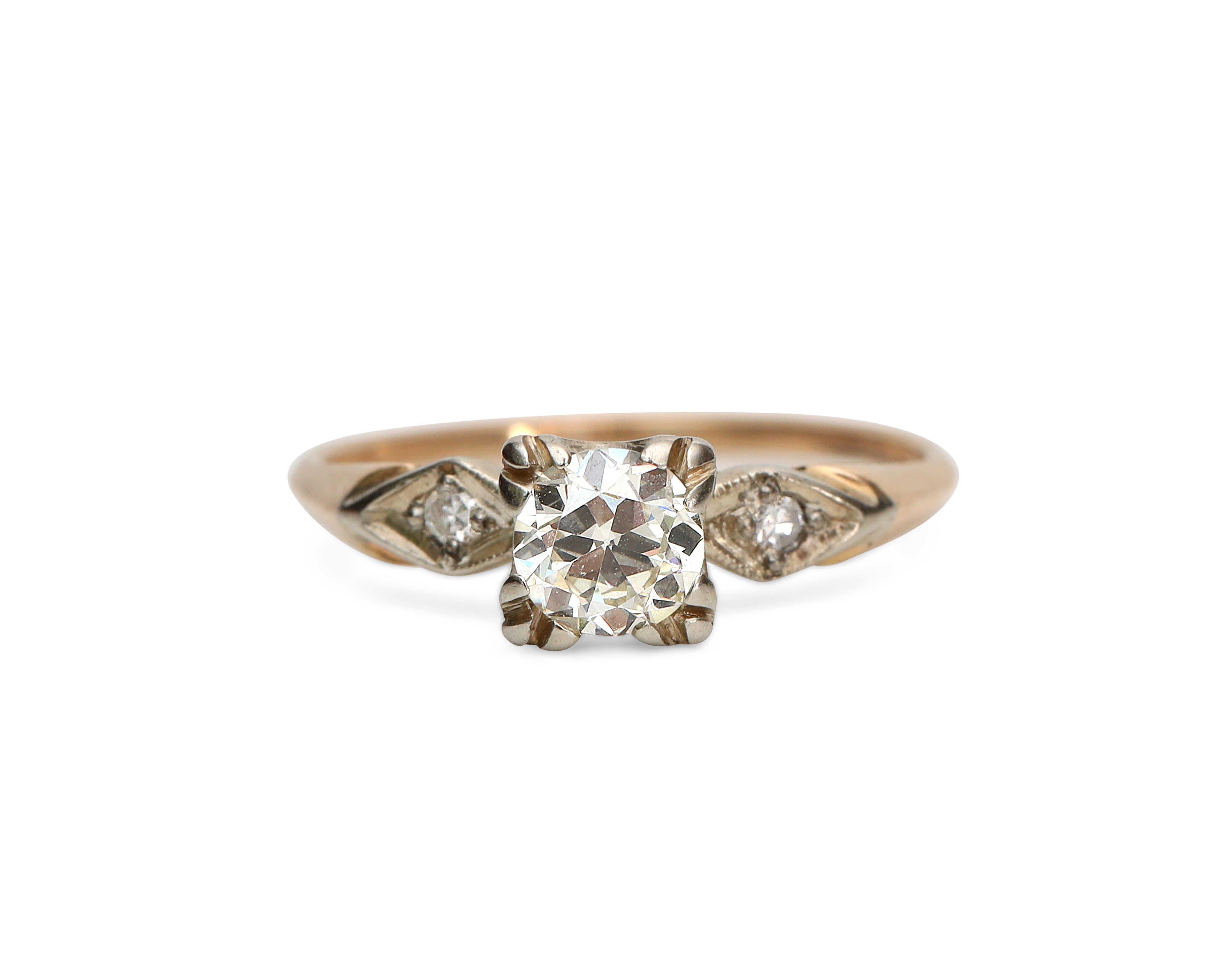 This classic diamond engagement ring features a lively 0.60 carat solitaire diamond set in the center with squared head. Two smaller diamonds add sparkle from shoulder to shoulder of the 14K yellow gold ring.

This is a true vintage piece, and we