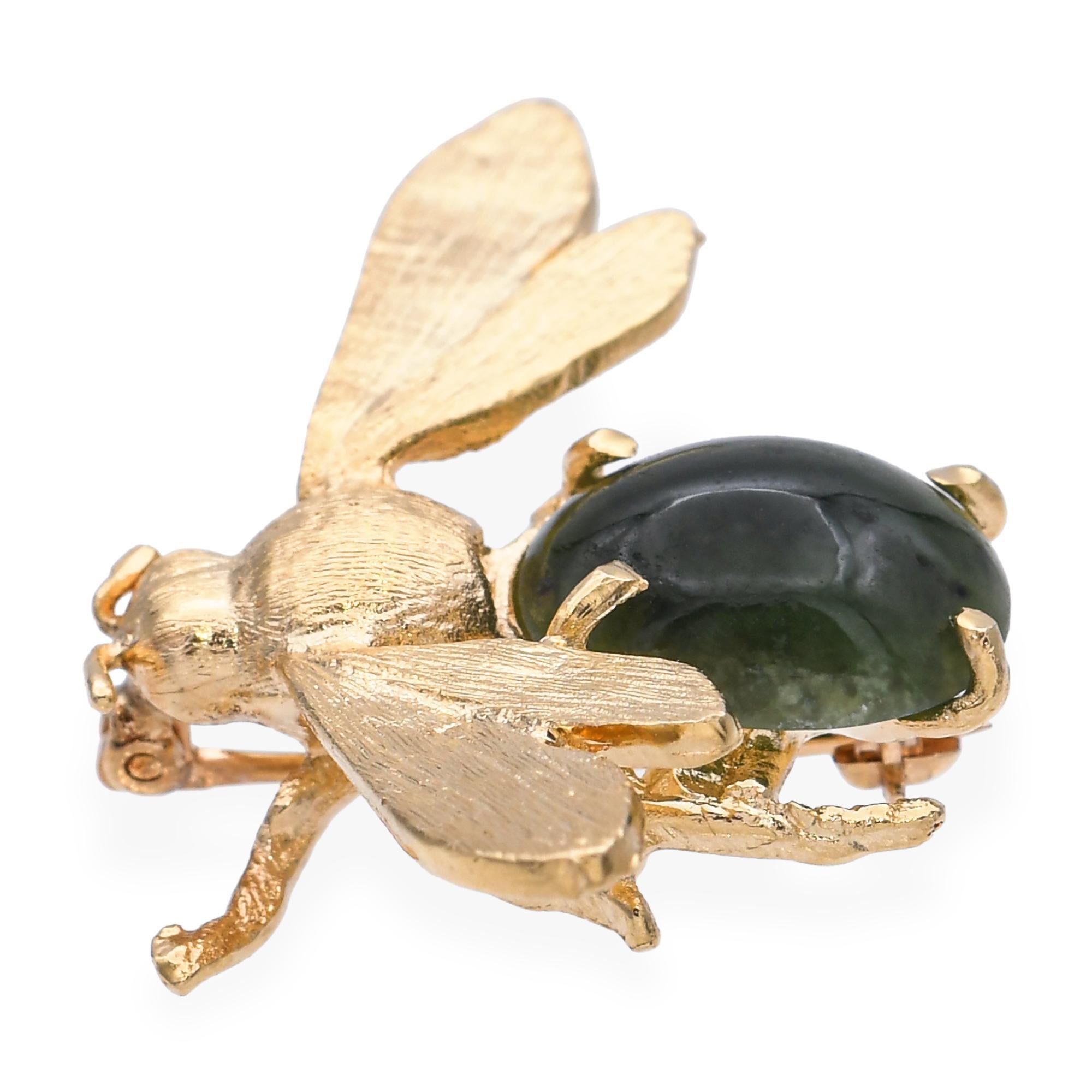 This vintage bumblebee brooch is crafted in 14k yellow gold and features beautifully carved jadeite as the body, showcasing soft green tones that add a natural elegance to the design. Intricate goldwork forms the wings, legs, and antennae, capturing