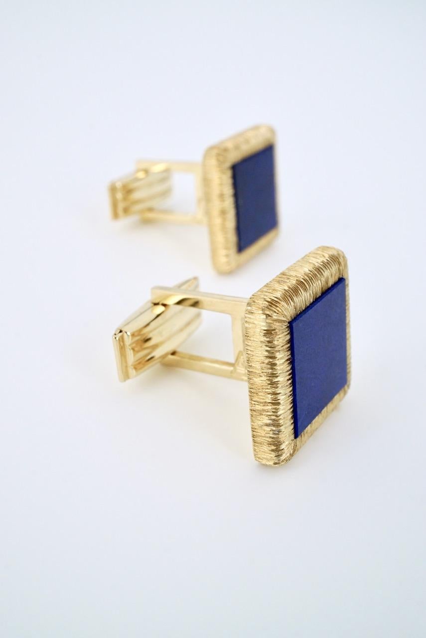 A vintage pair of 14k yellow gold and lapis square cufflinks with each cufflink consisting of a square tablet of rich bright blue lapis lazuli set within a finely textured 
