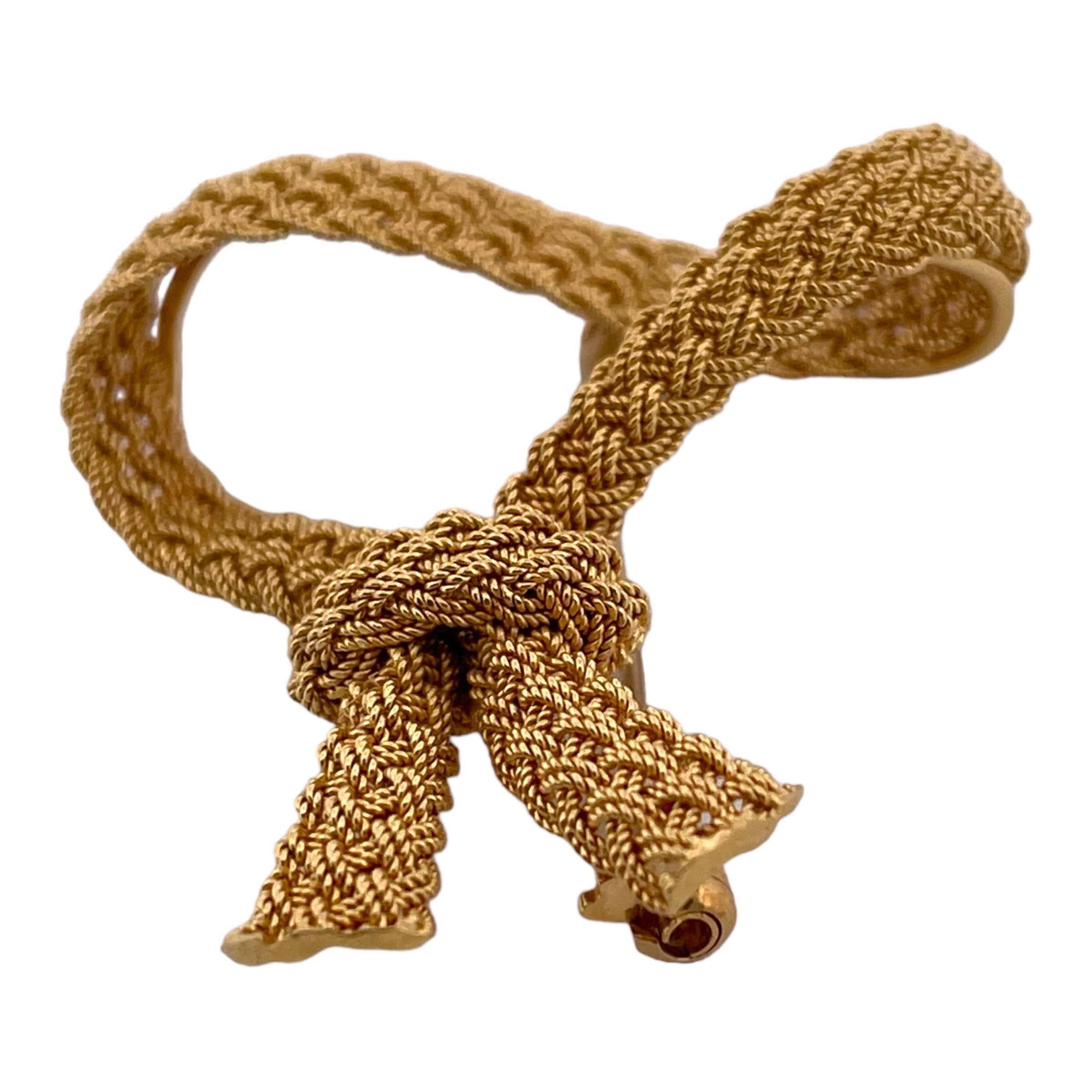 Step back in time with this exquisite Vintage Mesh Ribbon Brooch, fashioned from the finest 14K yellow gold. Weighing 9.6 grams, this intricately woven brooch captures the essence of classic elegance. Its mesh design creates a delicate ribbon-like