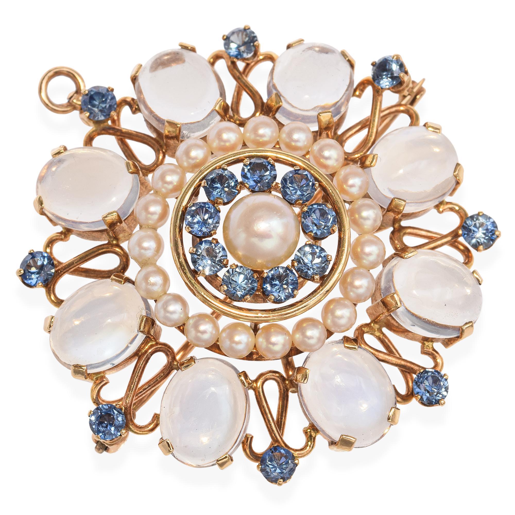 This vintage 14k yellow gold brooch pendant features a striking concentric design centered around a lustrous cultured pearl. A halo of rich blue sapphires surrounds the center, followed by a delicate ring of seed pearls that adds soft elegance. The