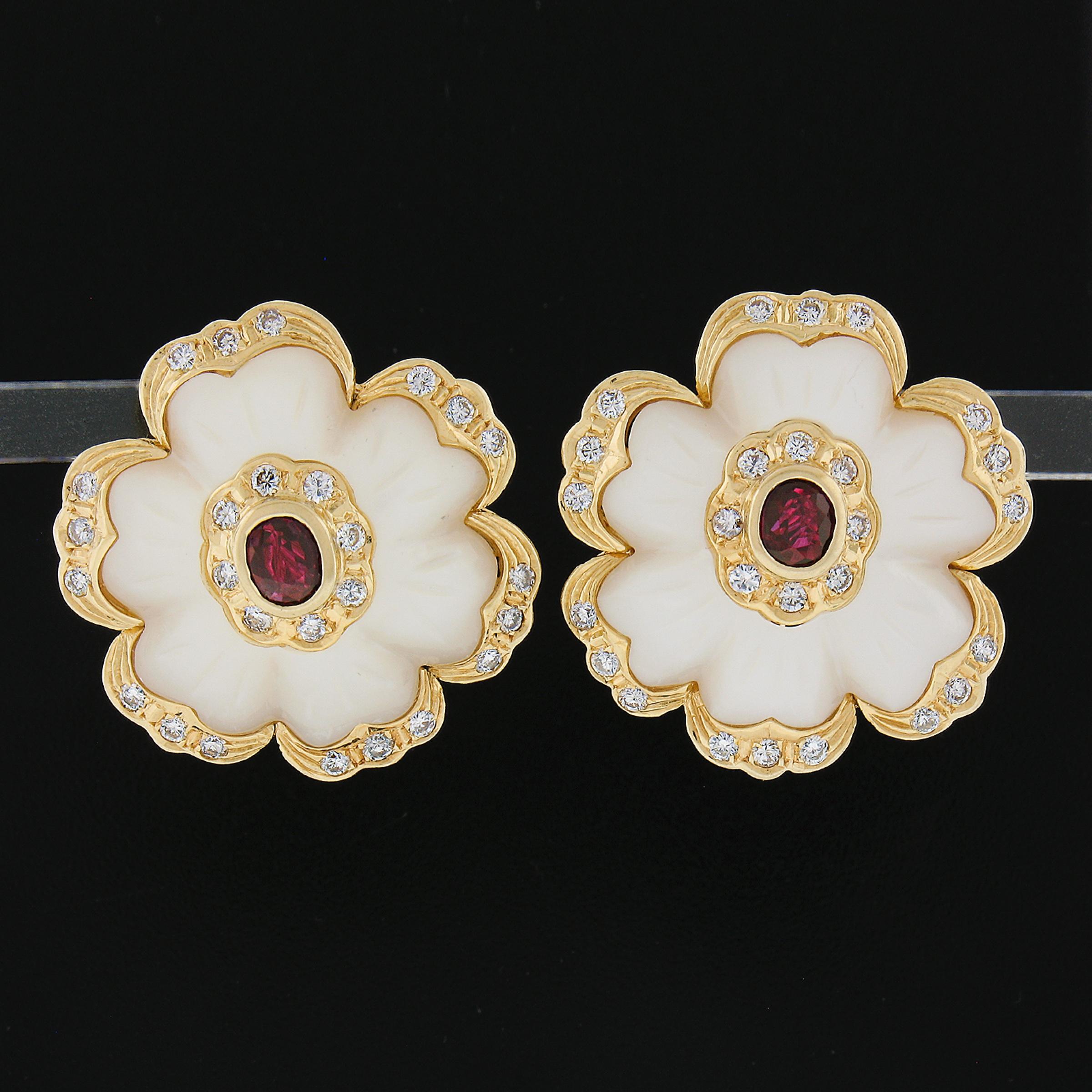 --Stone(s):--
(2) Genuine Mother Of Pearls - Carved Flower Shape - Bezel Set - Creamy White Color w/ Pink & Green Overtone -  21.7x20.1mm each (approx.)
(2) Natural Genuine Rubies - Oval Cut - Bezel Set - Deep Red Color - 5x4mm - 1.0ctw