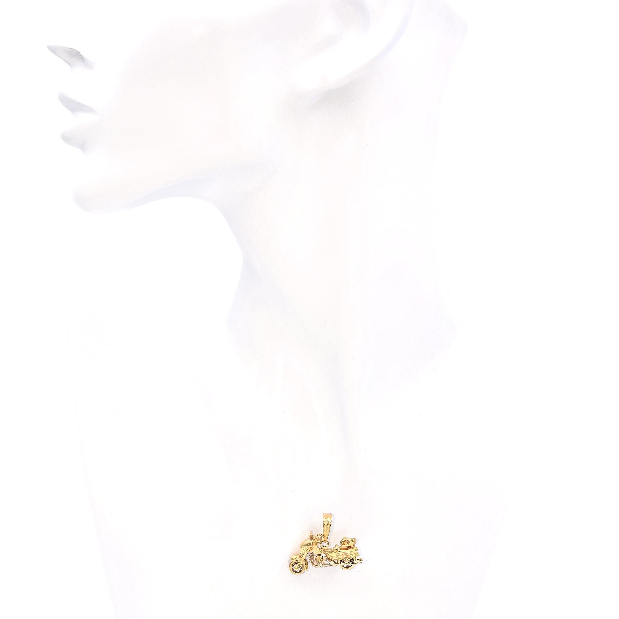This detailed motorcycle charm captures the spirit of adventure with its intricately designed 14K yellow gold construction. The charm features spinning wheels, allowing for a playful interactive element, while showcasing the artistry and fine