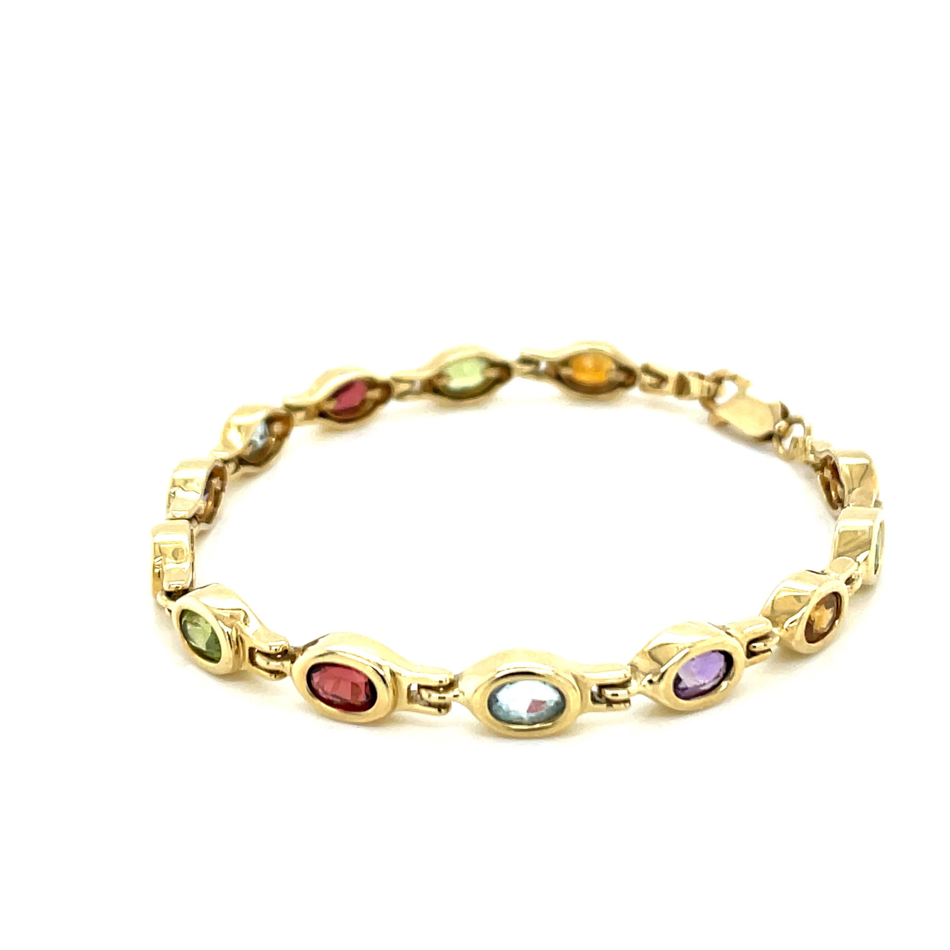 Vintage 14K Yellow Gold Multi Color Gemstone Bezel Bracelet  - There are 13 oval multi color gemstones measuring 6 x 4mm set in gold bezels. The order of the gemstones from the lobster clasp is: Garnet, Peridot, Citrine, Amethyst, Blue Topaz. The