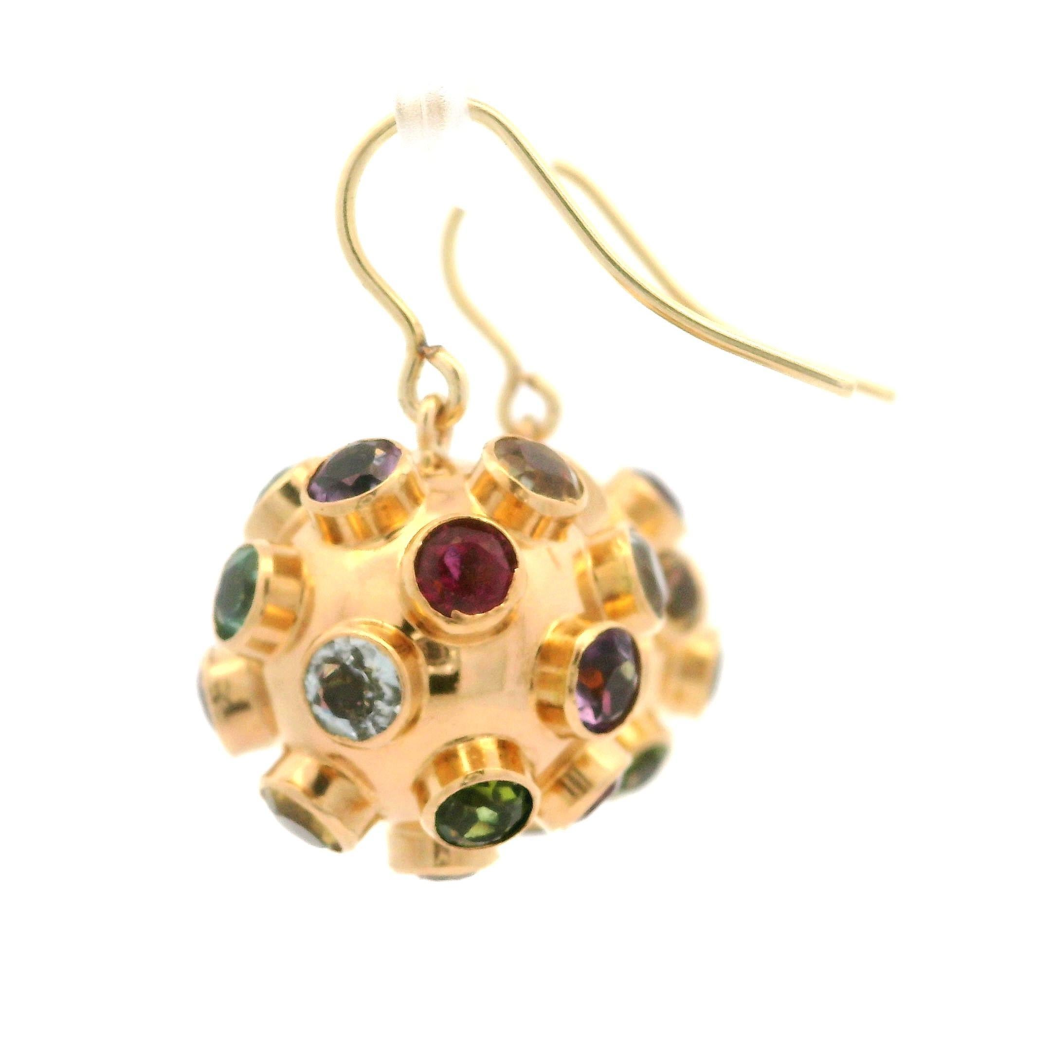 -- Stone(s) --
Numerous Genuine Gemstones - Tourmalines, Garnets, Citrines, Amethysts & Others - Round Cut - Bezel Set - Multi Colors

Material: 14K Yellow Gold
Weight: 9.37 Grams
Backing: Hook Closures (Pierced ears are required.)
Overall Width: