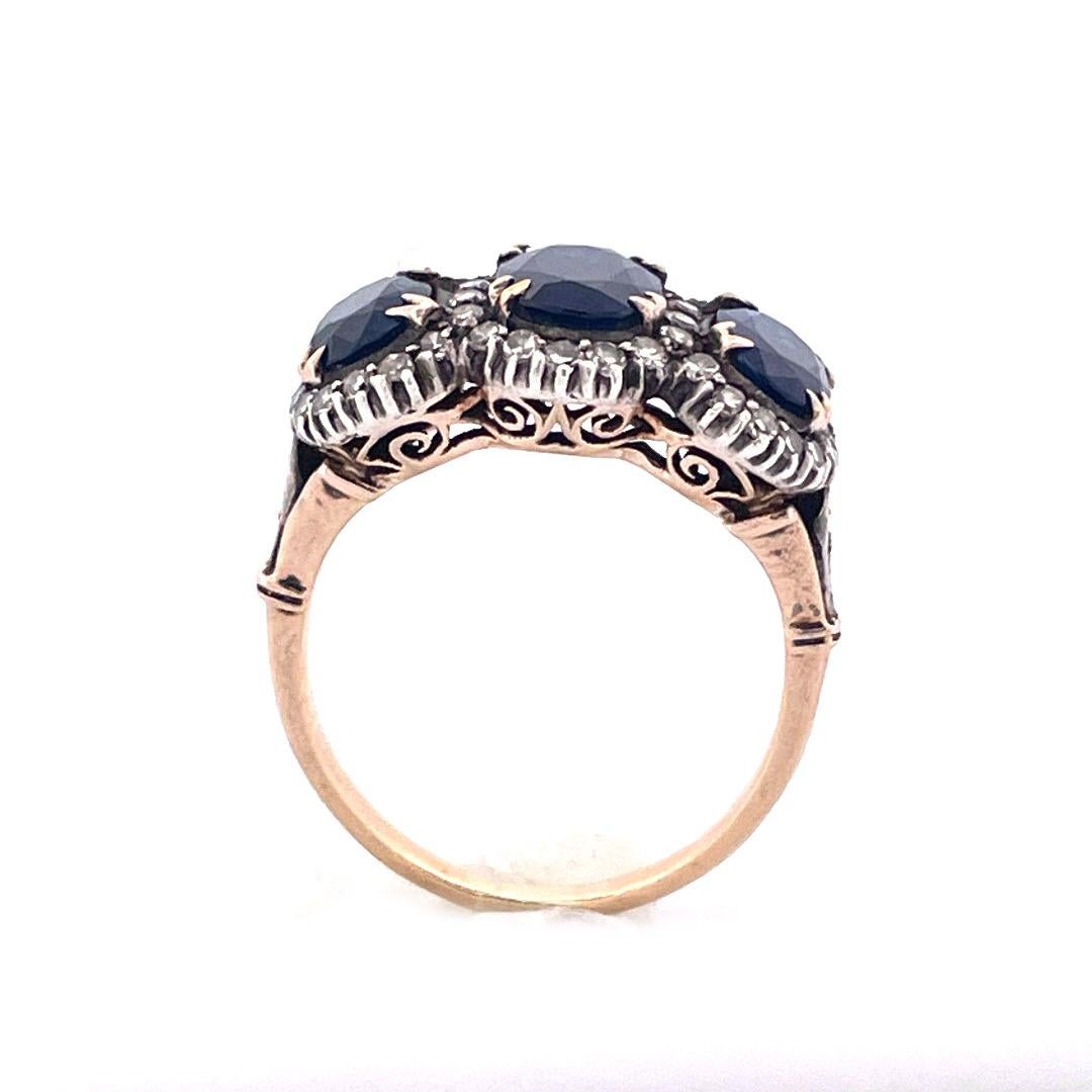 Embrace the allure of vintage charm with this stunning 14K yellow gold natural sapphire ring. This ring features three sapphire diamonds of 3.5 tcw, surrounded by natural diamonds of 0.95 TCW. Weighting 4.2 grams, his ring radiates warmth and