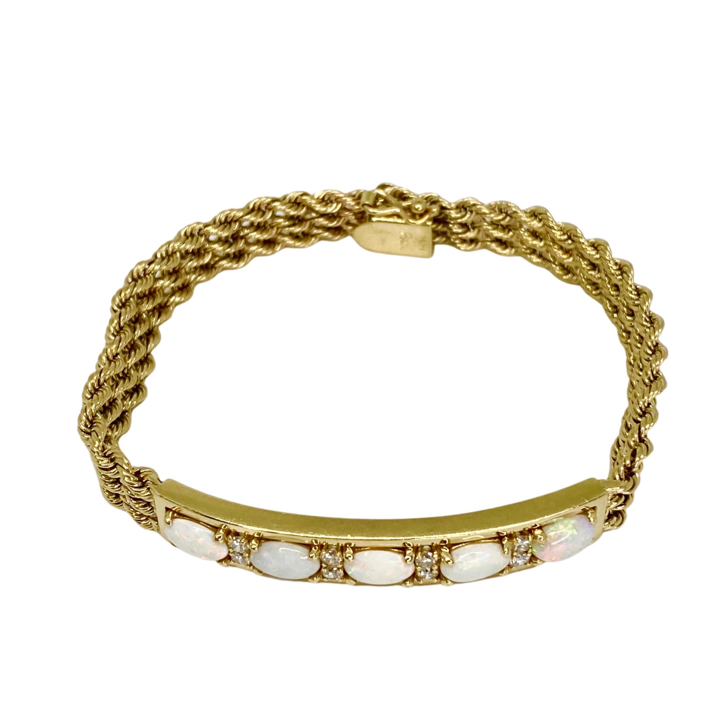 Vintage 14K yellow gold bracelet featuring an opal and diamond set gold frame, supported by flexible triple- rope chain bracelet. 
5 oval opals: approximate total weight: 2.0ct
8 round brilliant cut diamonds: approximate total weight: 0.40ct. Color: