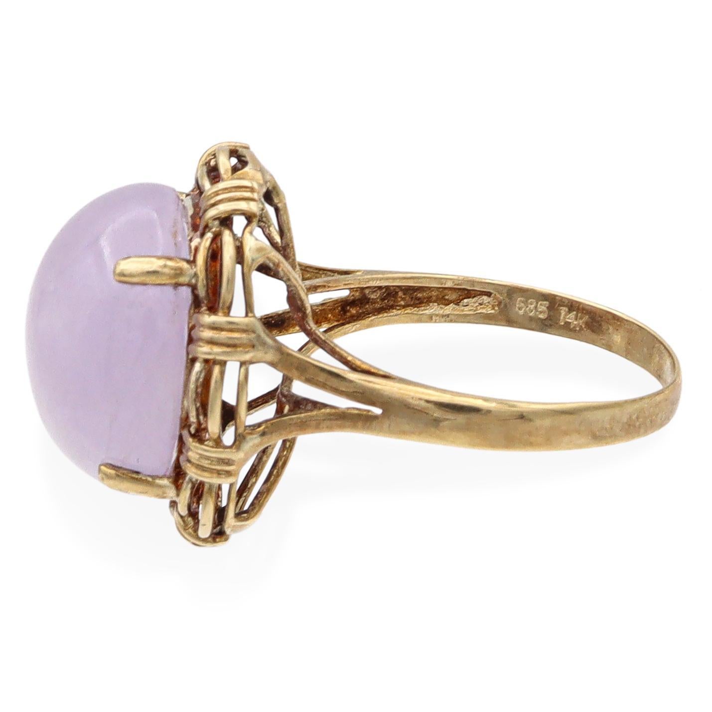 A striking cocktail ring featuring a large oval-shaped purple jade stone. The jade is encircled by an intricate 14k yellow gold setting, enhancing its elegant appearance. This exquisite piece is designed to captivate and impress.

Weight: 5.5
