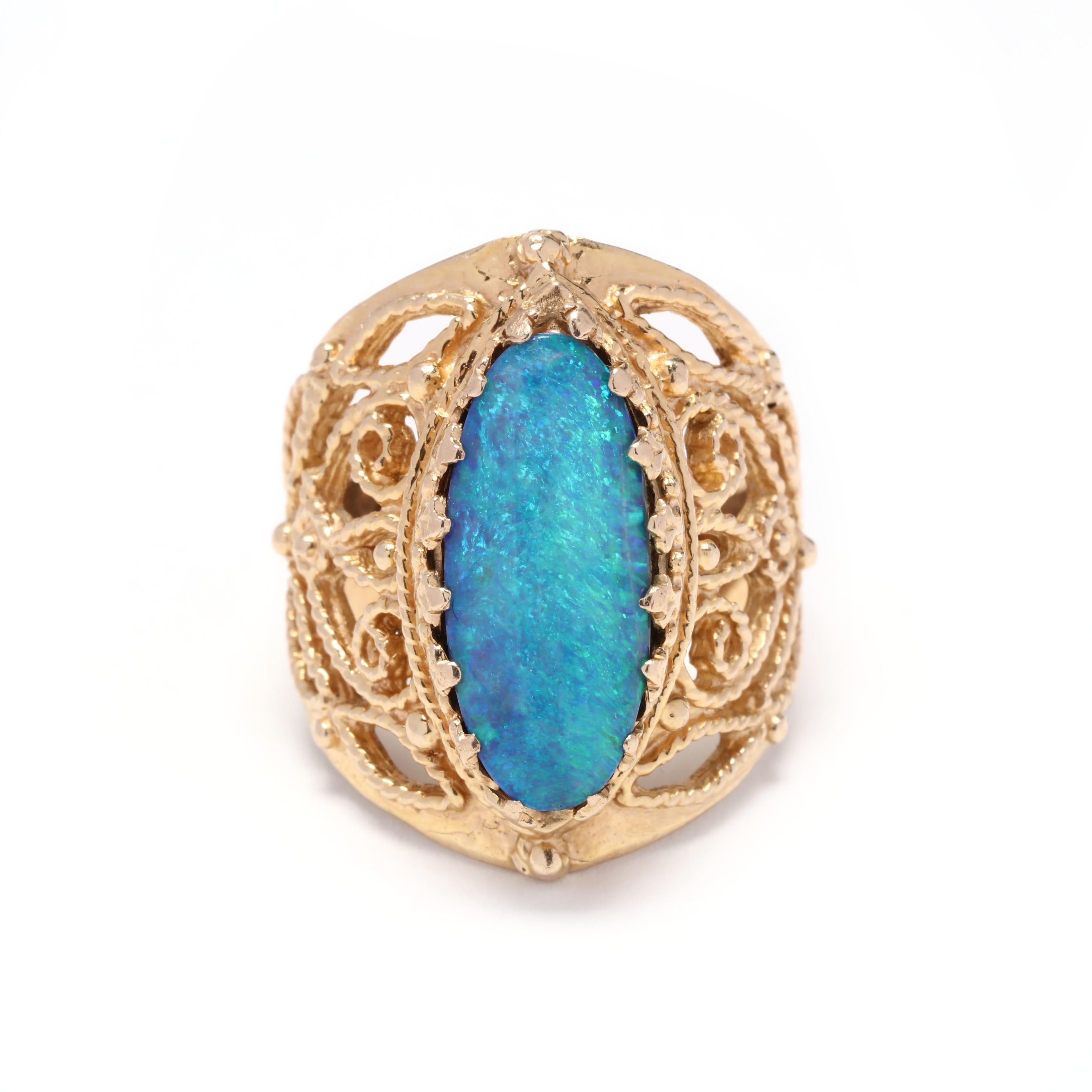 A vintage 14 karat yellow gold oval opal filigree navette statement ring. This ring features an oval cabochon cut opal with trefoil prongs and a rope motif filigree mounting.

Stones:

- opal, 1 stone

- oval cabochon

- 18.82 x 8.7 mm


Ring Size