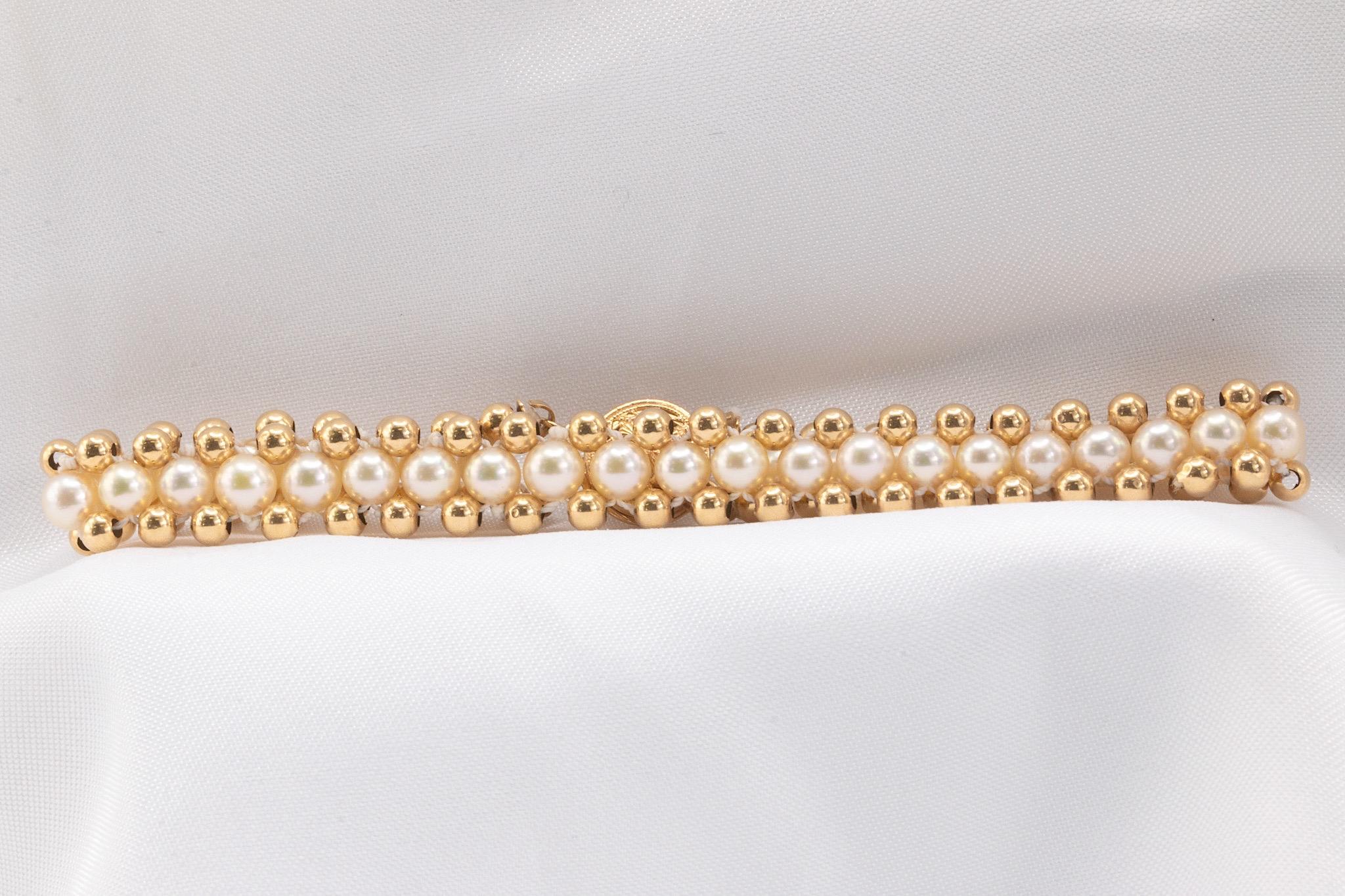 This exquisite vintage bracelet from the 1980s features 38 lustrous pearls beautifully accented by 78 gold beads, crafted in 14k yellow gold. Measuring 7 inches in length and 8.5mm in width, this delicate piece is both lightweight and striking,