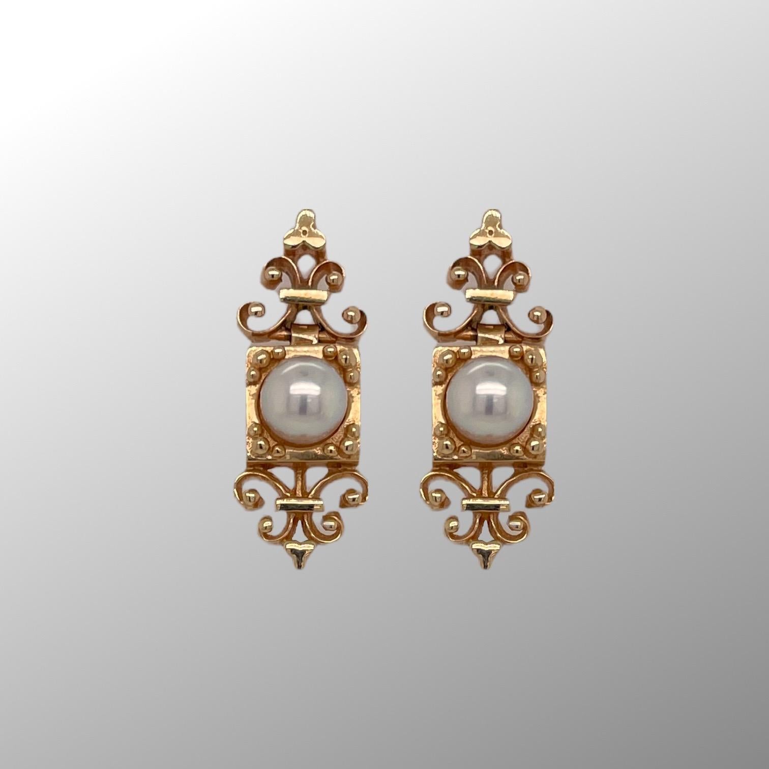 Vintage style earrings are in 14k yellow gold and contain two 5.8mm south sea pearls. Earrings measure approximately 1
