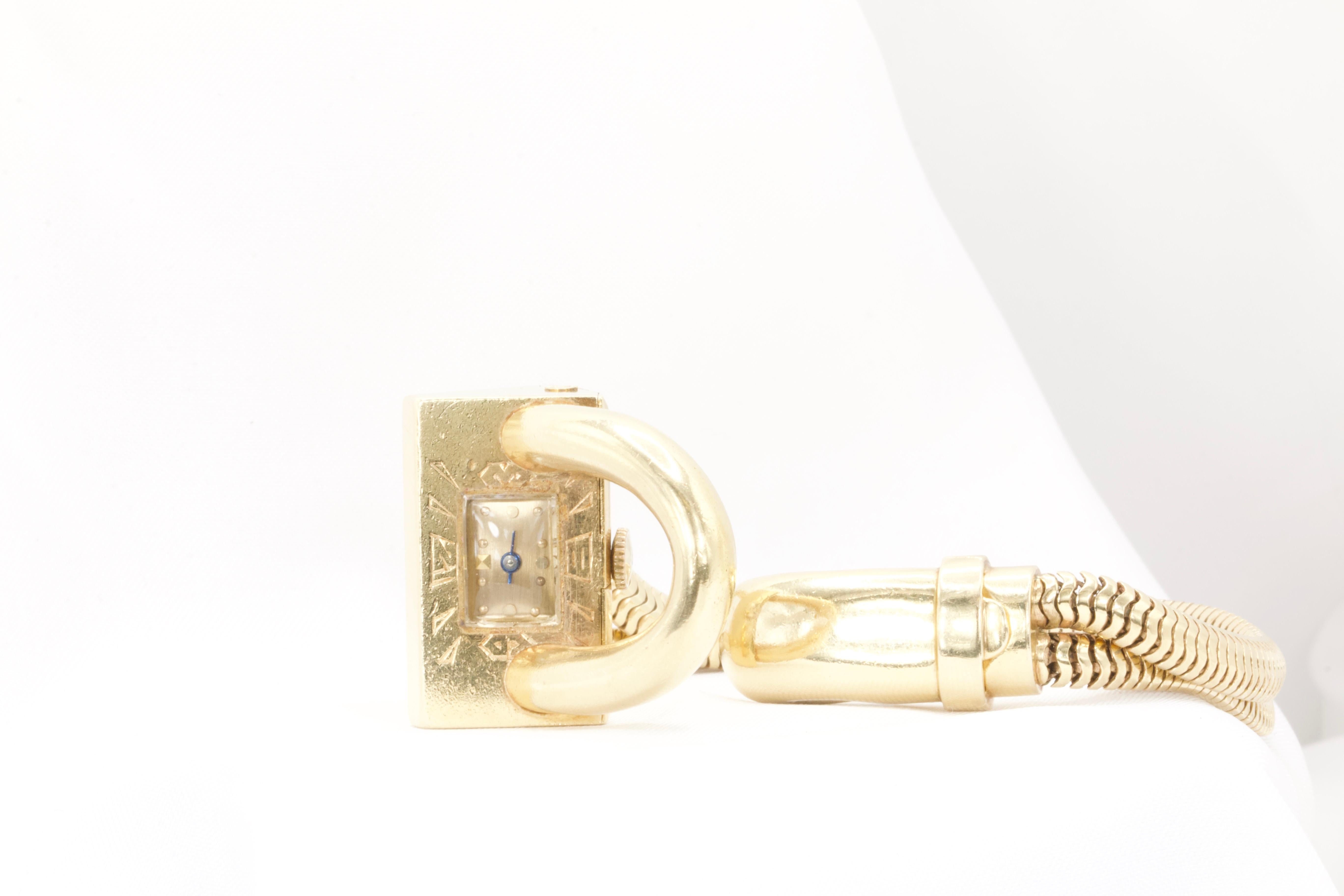 Elegant retro vintage wristwatch crafted in solid 14k yellow gold. This sophisticated timepiece is a true statement of timeless style.  

The watch features a rectangular case measuring approximately 1.4 inches in diameter, 1 inch in width, and 0.60
