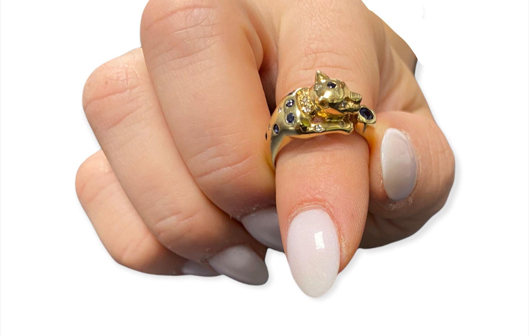 This spectacular antique panther ring handcrafted in the early 1900 features 14k yellow gold, luscious sapphires and white diamonds. An array of white diamonds (.45cttw) accent the perfect blue color of the sapphire gemstone center stone (.25ct) The