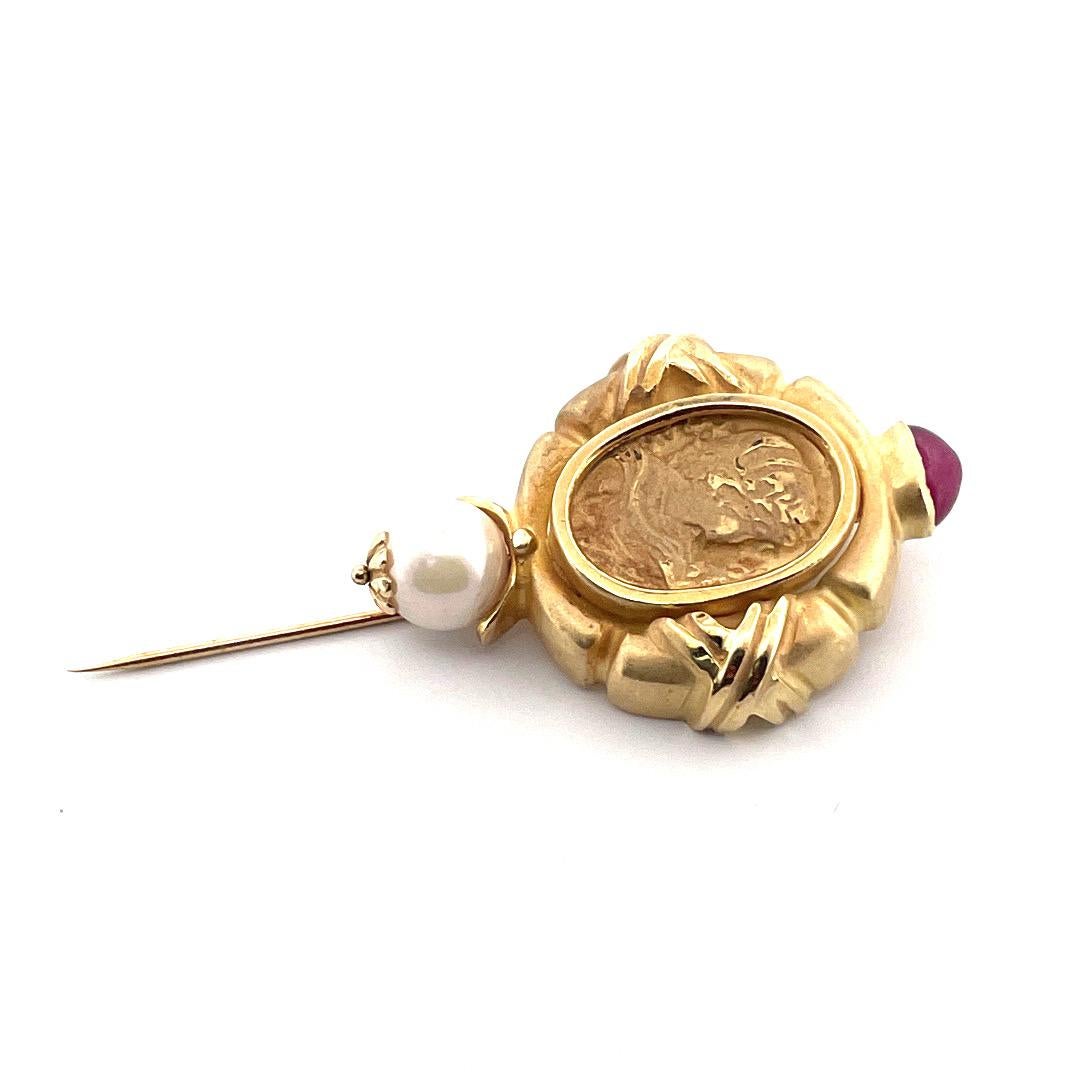 Embrace timeless elegance with our Vintage 14K Yellow Gold Ruby and Cultured Pearl Cameo Stick Pin. This exquisite piece showcases a beautifully carved cameo on gold, featuring the delicate face of a Victorian-style girl. This pin is adorned with