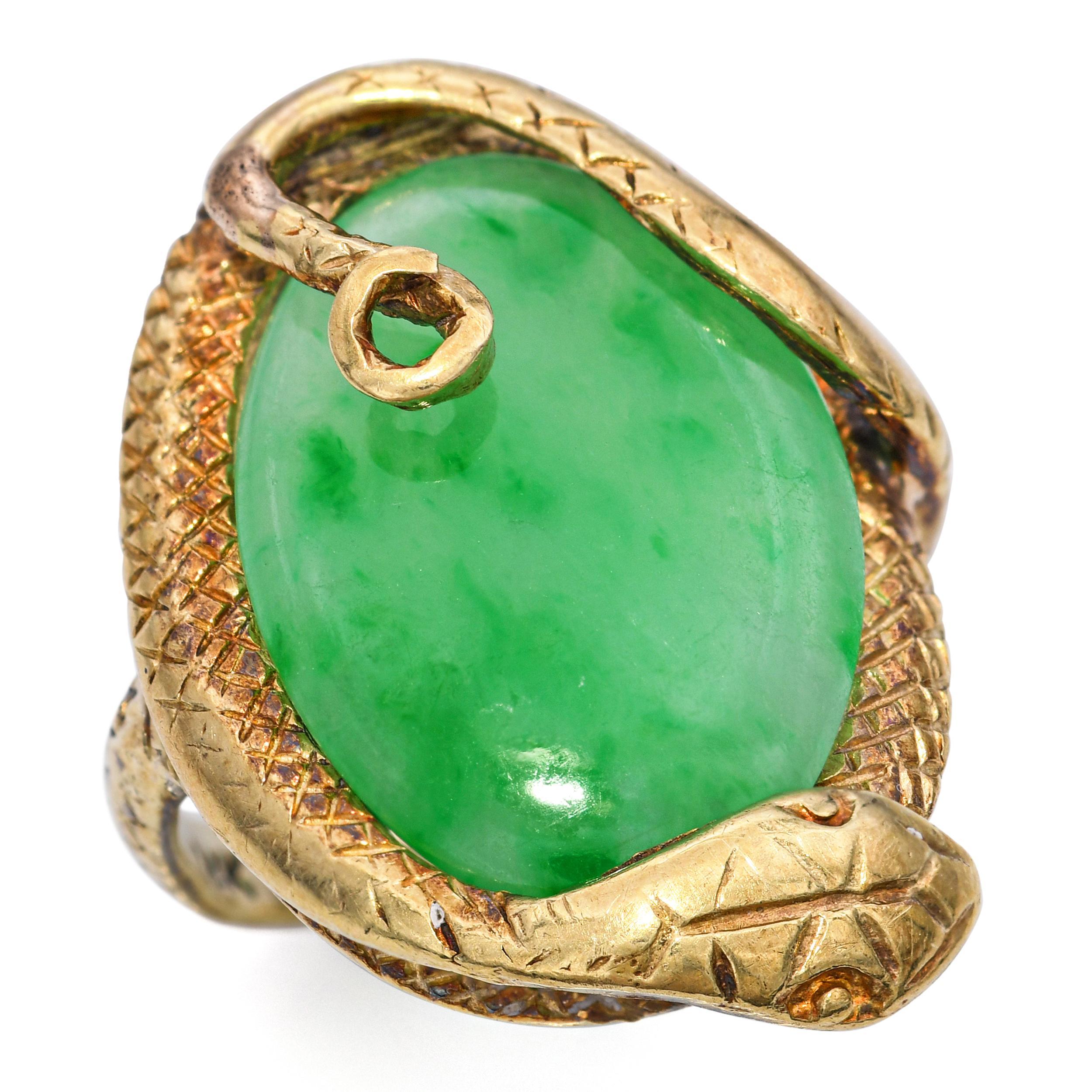 Vintage 14k Yellow Gold Snake Jade Ring, featuring a richly carved green jade cabochon embraced by a coiled snake motif. The serpent design is detailed in warm 14k yellow gold, symbolizing protection, eternity, and transformation. The smooth polish