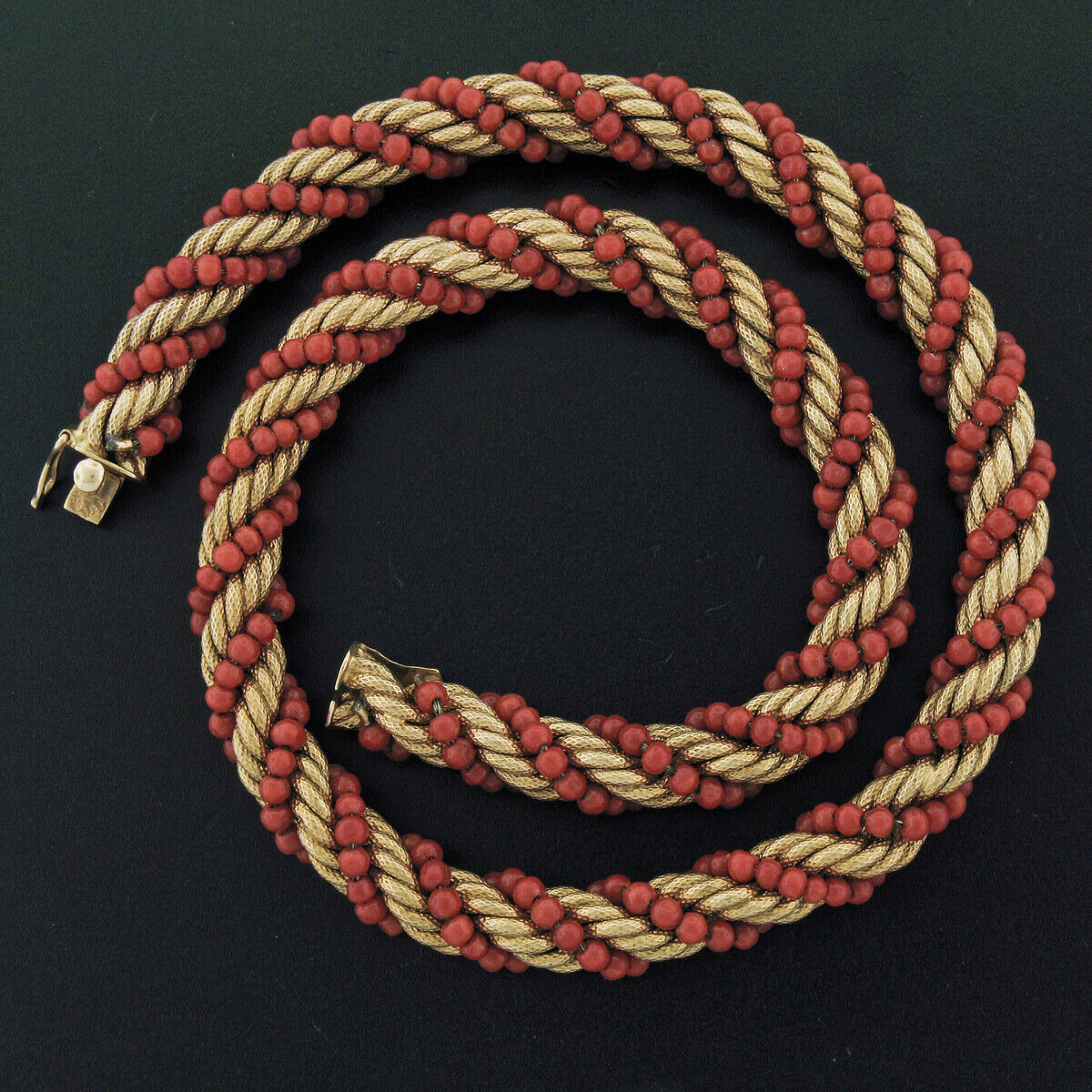 Here we have a vintage intertwined 14k yellow gold rope link and natural coral bead strand. The rope chain has a unique textured finish and displays very lovely patina which has been preserved adding an authentic vintage touch to the design. The