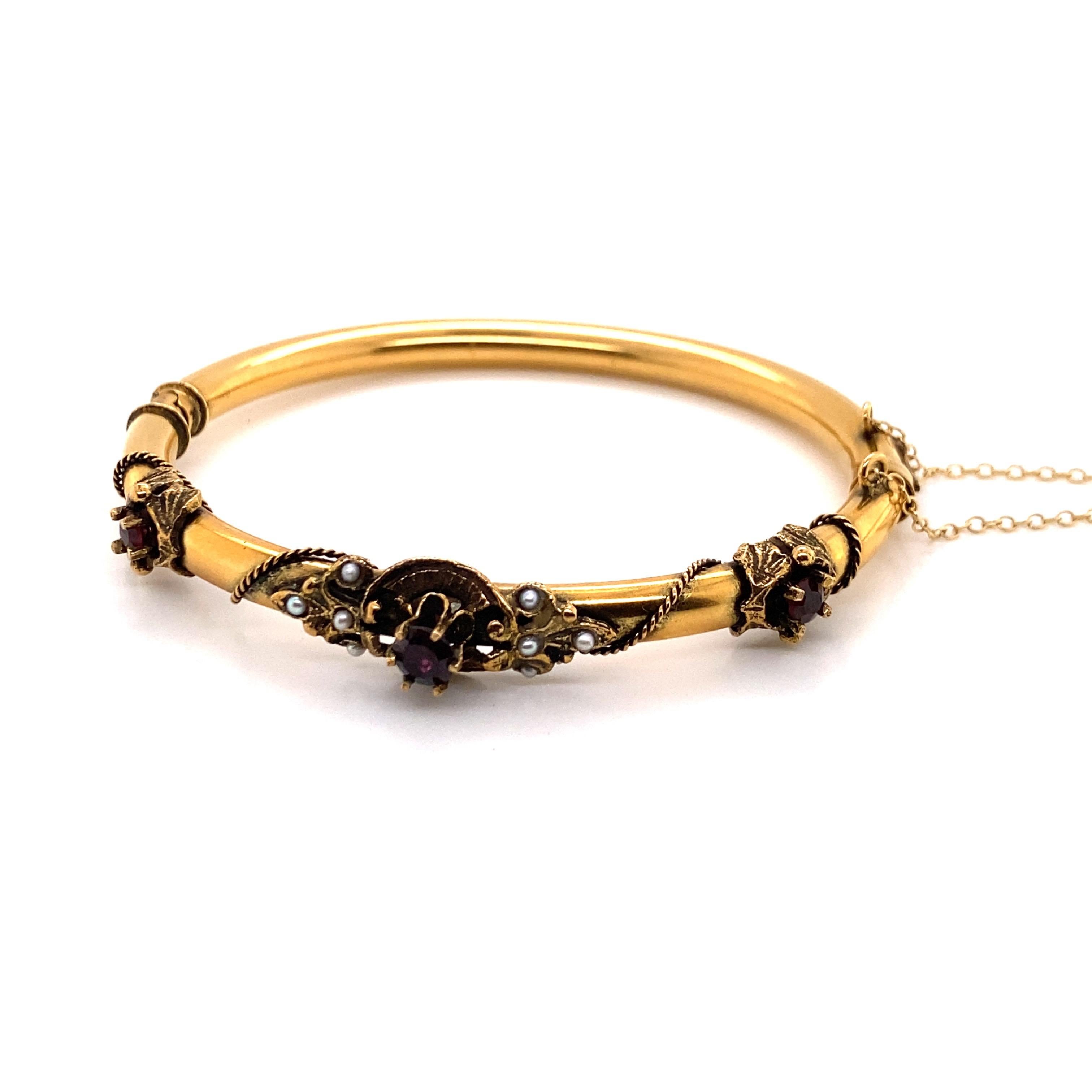 Vintage 14K Yellow Gold Victorian Reproduction Bangle with Garnets and Seed Pearls - The bangle measures 4.7mm wide. The inside diameter is 1.9 inches high and 2.2 inches wide. The bracelets weight is 13.08 grams.
