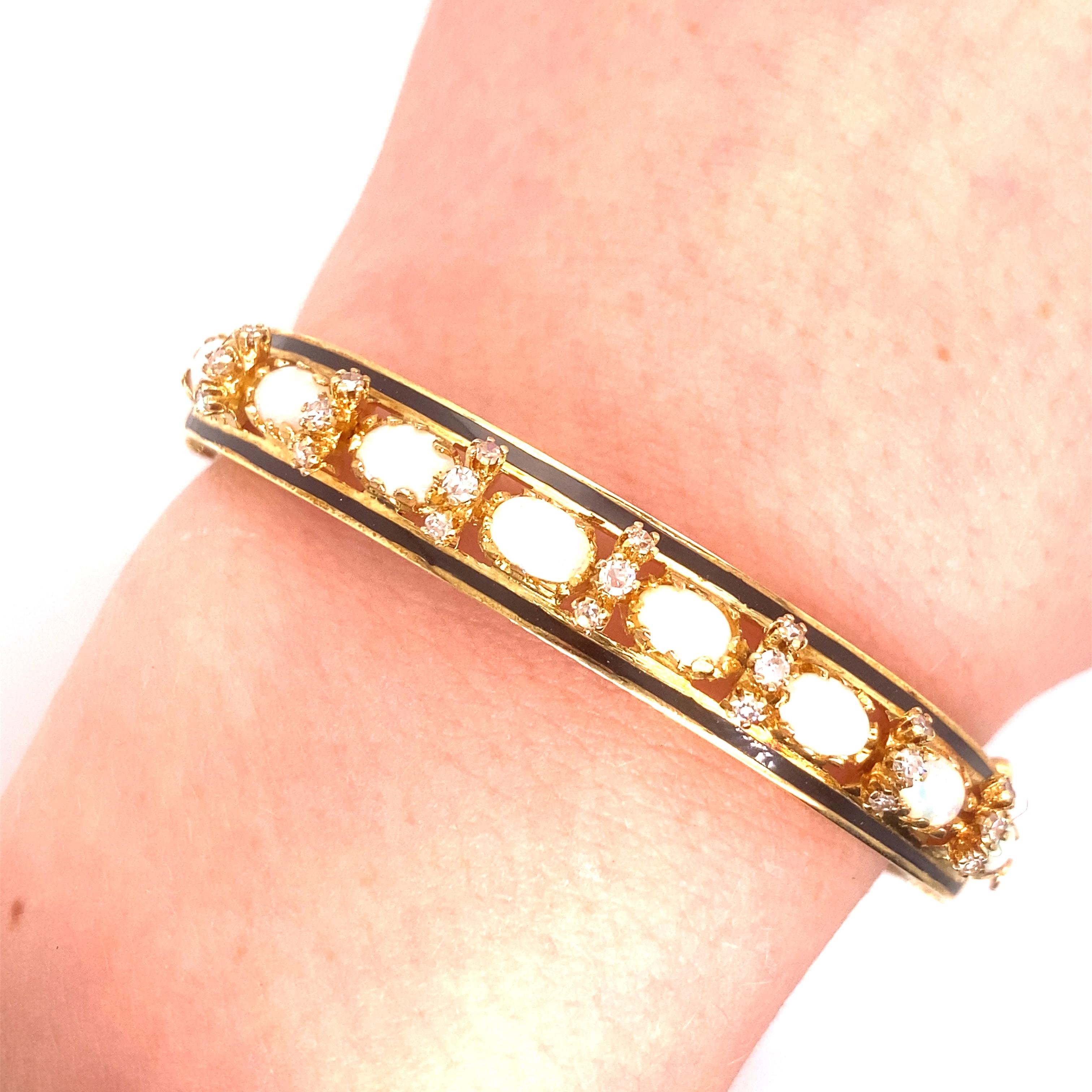 Vintage 14K Yellow Gold Victorian Reproduction Opal and Diamond Bangle Bracelet - The bangle contains 8 oval opals approximately 6 x 4mm with red and green play of color. There are 21 single cut diamonds accented in between the opals that weigh