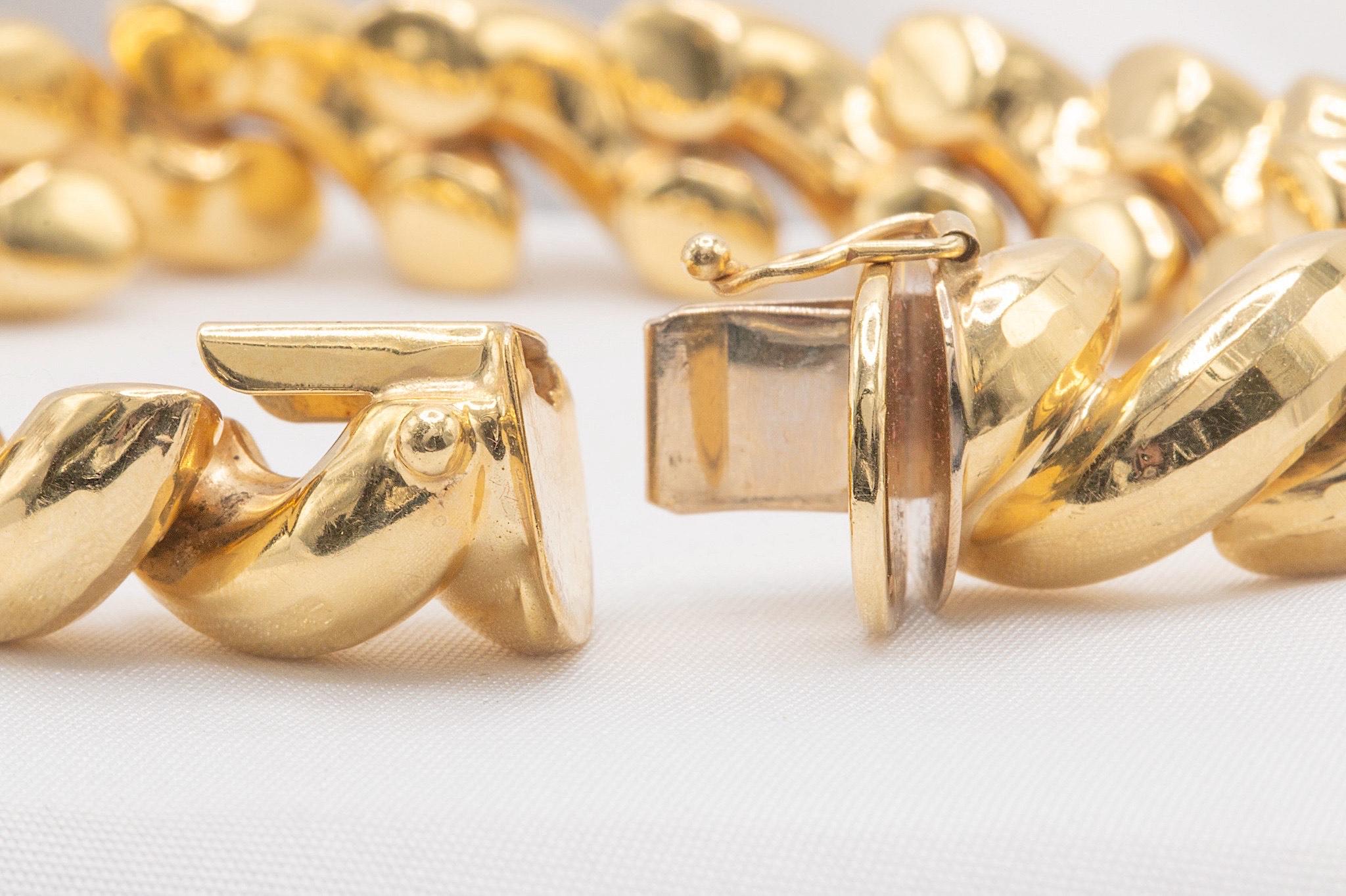 This exquisite vintage textured twist bracelet is crafted from 14k yellow gold and showcases a beautifully intricate design. Weighing 24.30 grams, it measures 7.3 inches in length and 11.4mm in width. As a true vintage piece, it may exhibit light