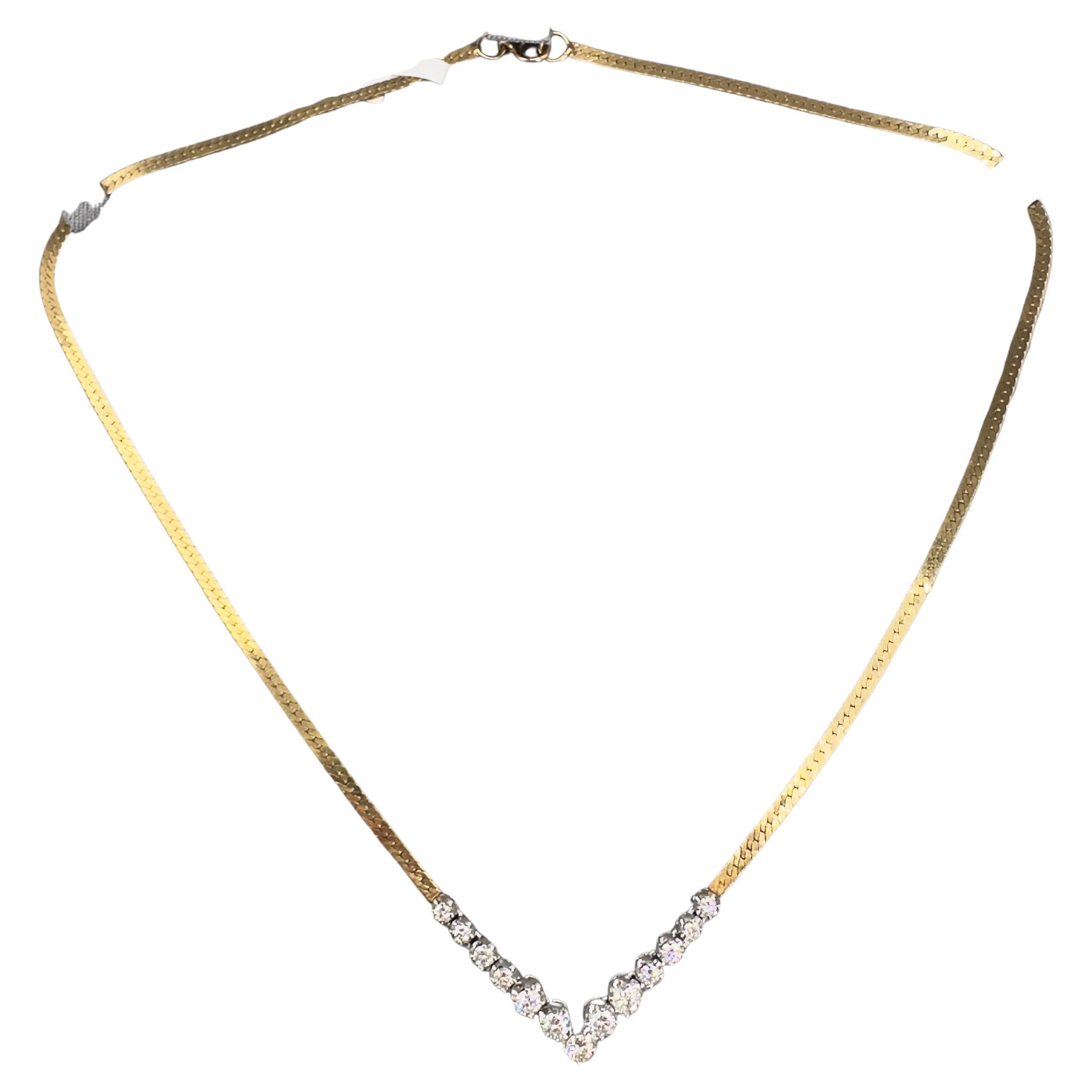 Este exquisito collar vintage de diamantes está meticulosamente elaborado en oro amarillo y blanco de 14 quilates, y exhibe 13 diamantes brillantes redondos que suman aproximadamente 1,25 quilates. Con color H-I y claridad SI, estos diamantes añaden