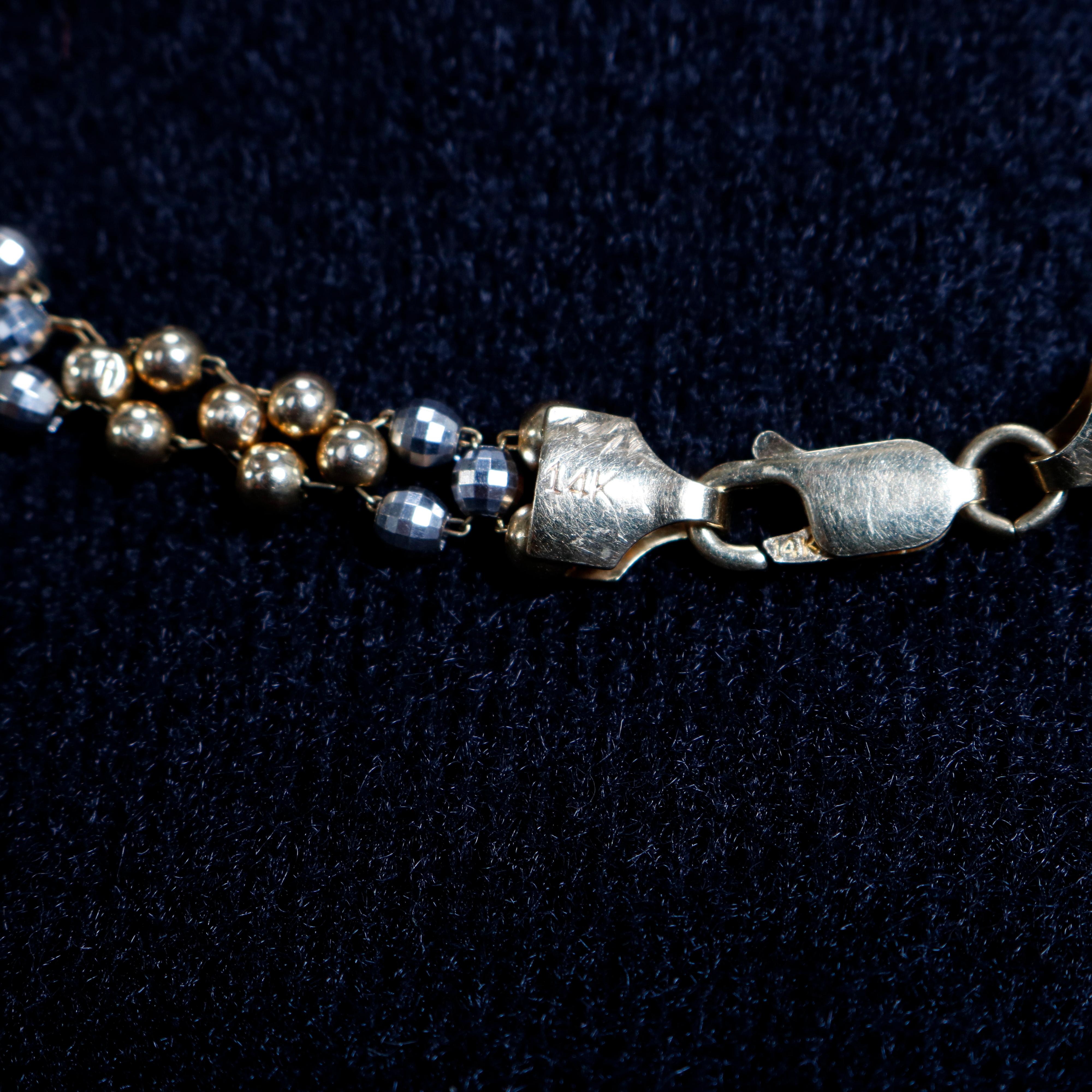 A vintage woman's necklace offers 14-karat gold woven beads, marked on clasp as photographed, 20th century


Measures: 17.75