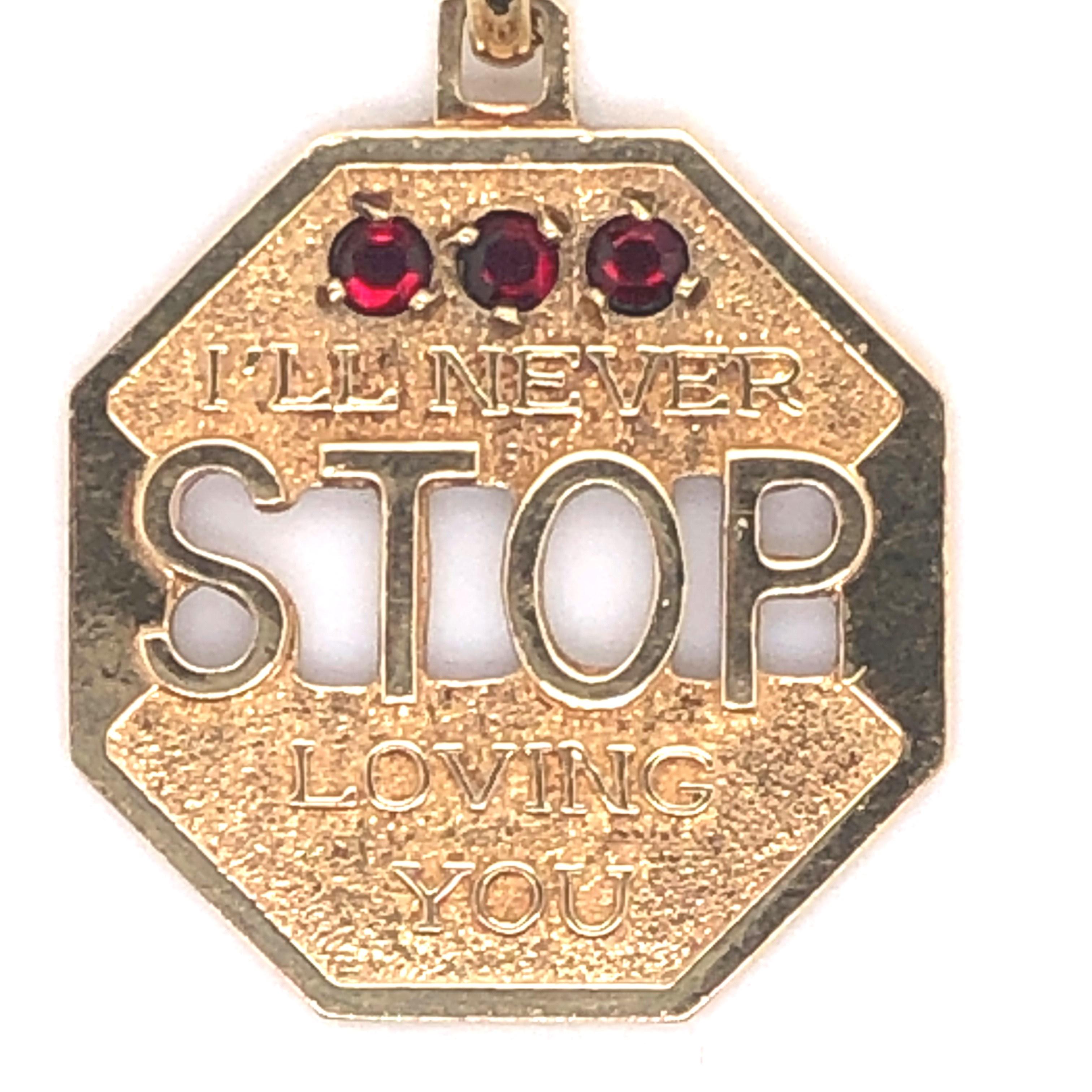 14kt yellow gold octagonal charm shaped like a stop sign with the words 