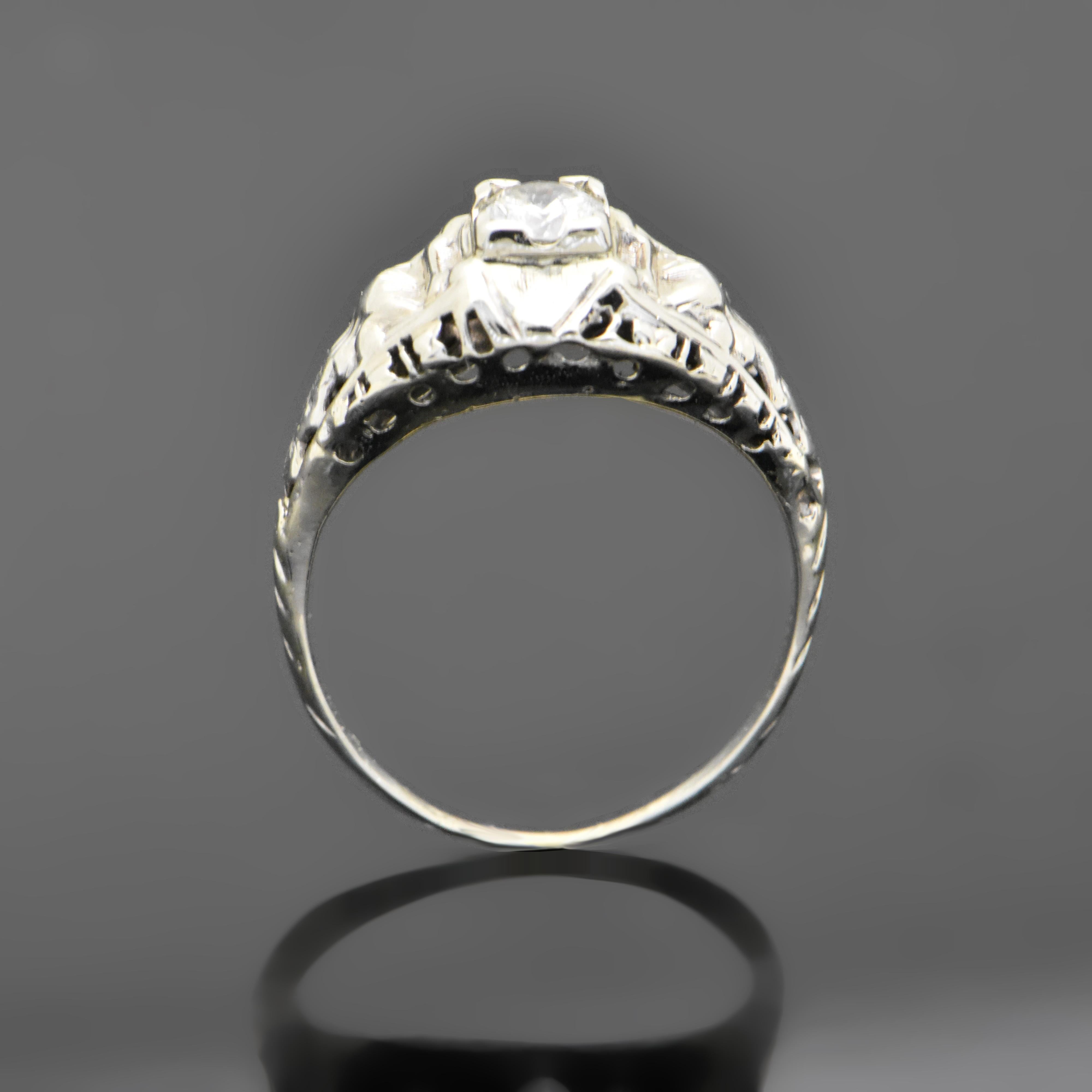 This is a vintage 14kt white gold Art Deco ring featuring a round diamond with an estimated weight 0.30 ct. Estimated weight of gold is 2 gr. 
We will size it for you.

