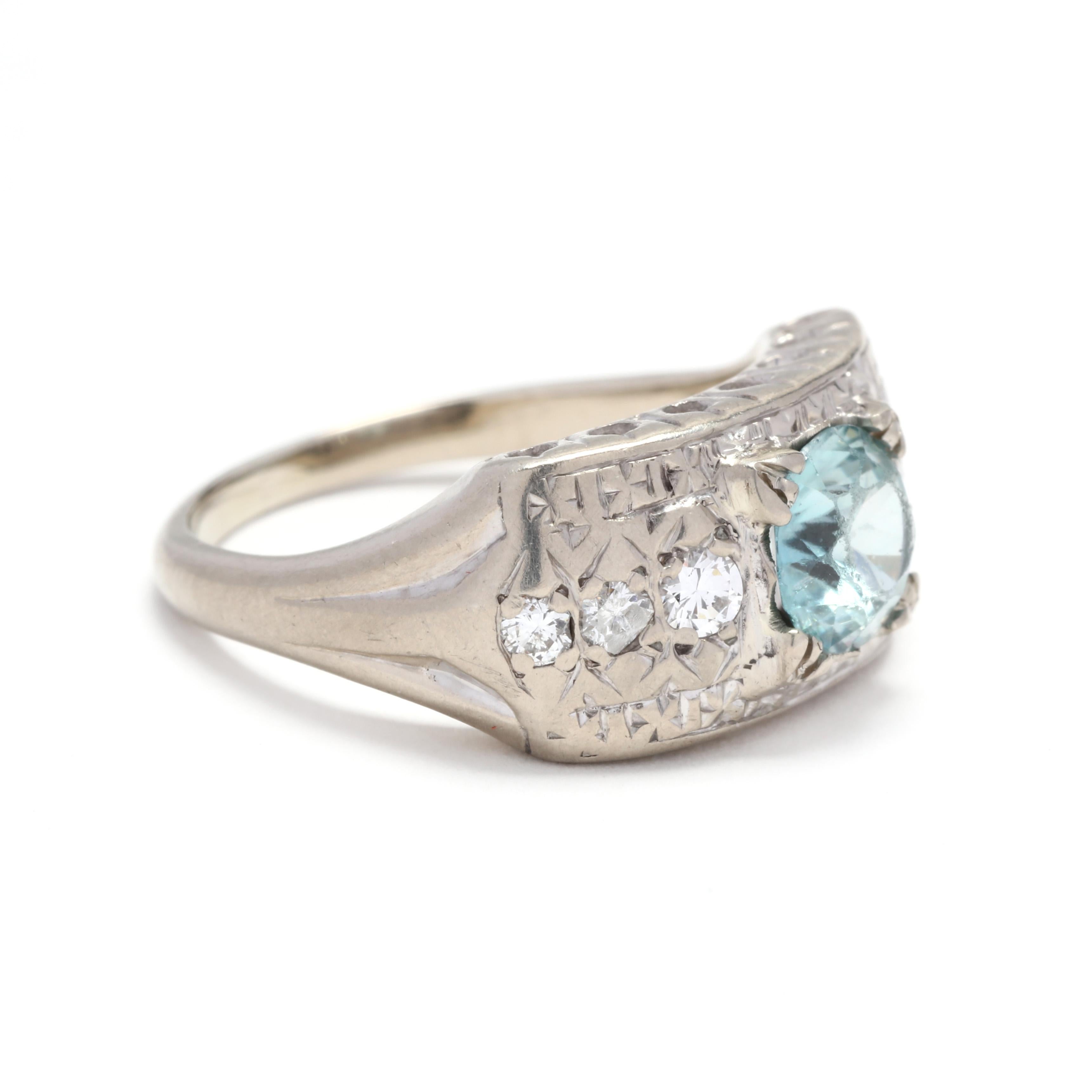 A vintage 14 karat white gold, blue zircon and diamond engagement statement ring. This ring features a round brilliant cut blue zircon weighing approximately 1.20 carats set on a wide band with three round brilliant cut diamonds on either side