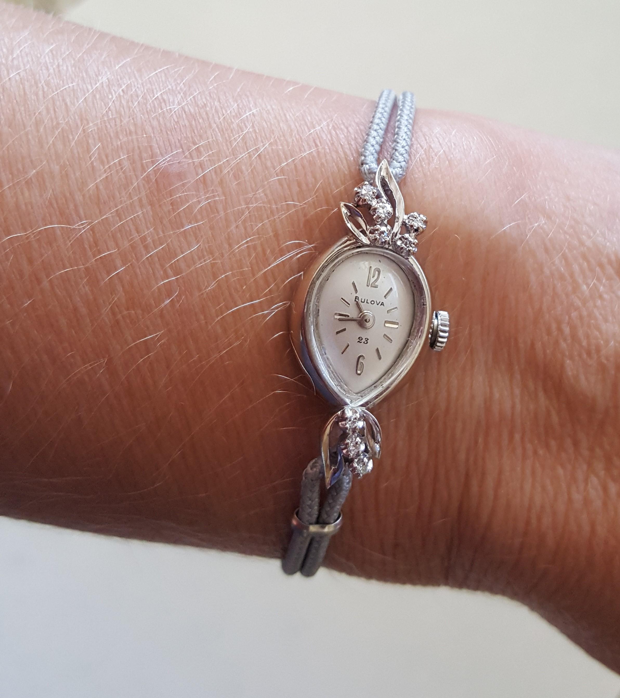 Vintage 14kt White Gold Bulova Ladies Watch, 23 Jewel, Very Good Condition, 8 Diamonds of approximately .16cttw, f/g color, clarity, Working, 18mm x 14mm Case, Thick Crystal. The watch is 6.5 inches long total, each side of the rope bracelet is 2