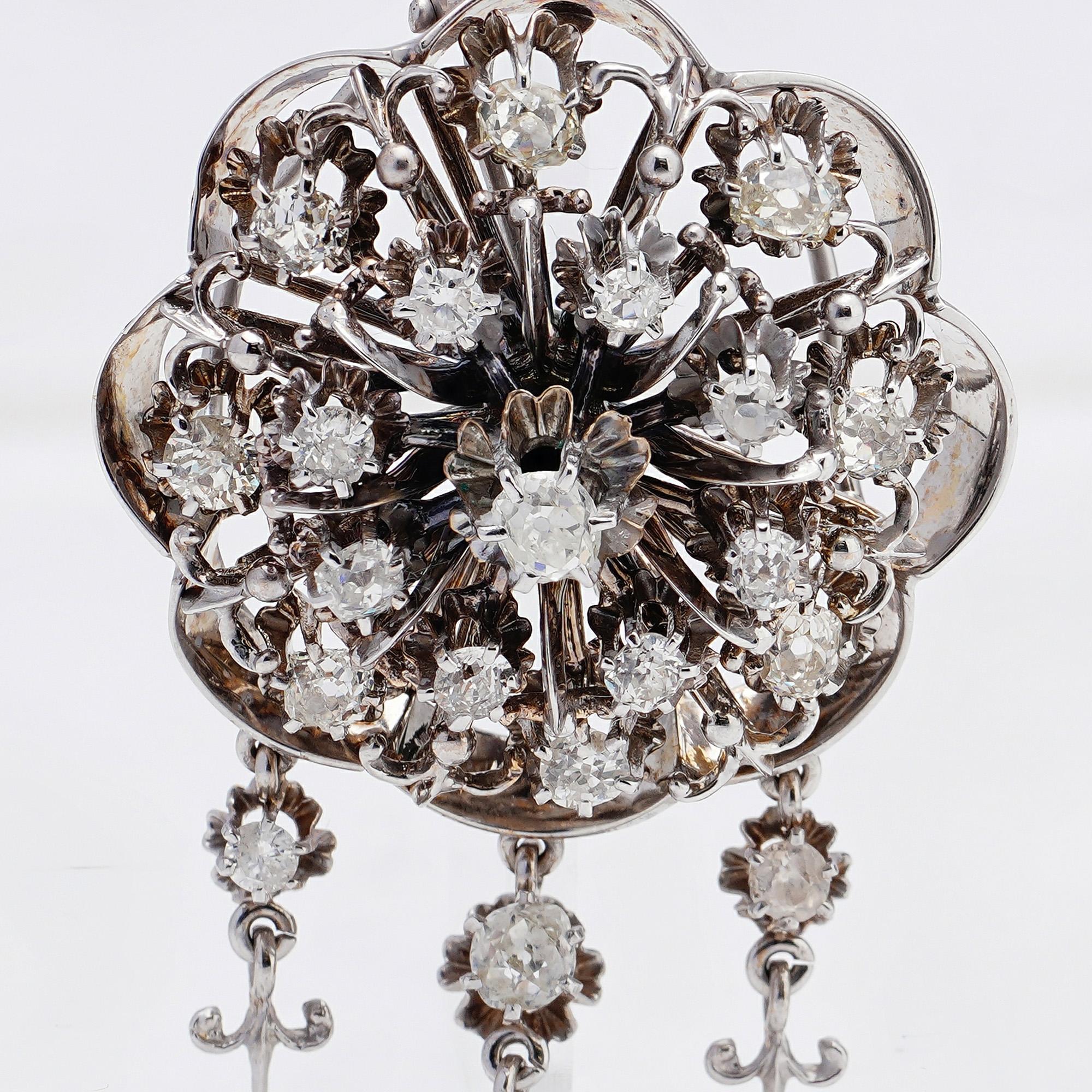Vintage 14kt. white gold flower brooch/pendant set with 3.10 ct. rose and old cut diamonds. 
Made in circa 1930's 
Hallmarked for 14kt. white gold. 

Dimensions - 
Diameter x height: 3.5 x 2.5 cm 
Weight : 19.53 grams

Diamonds - 
Cut: Old and rose