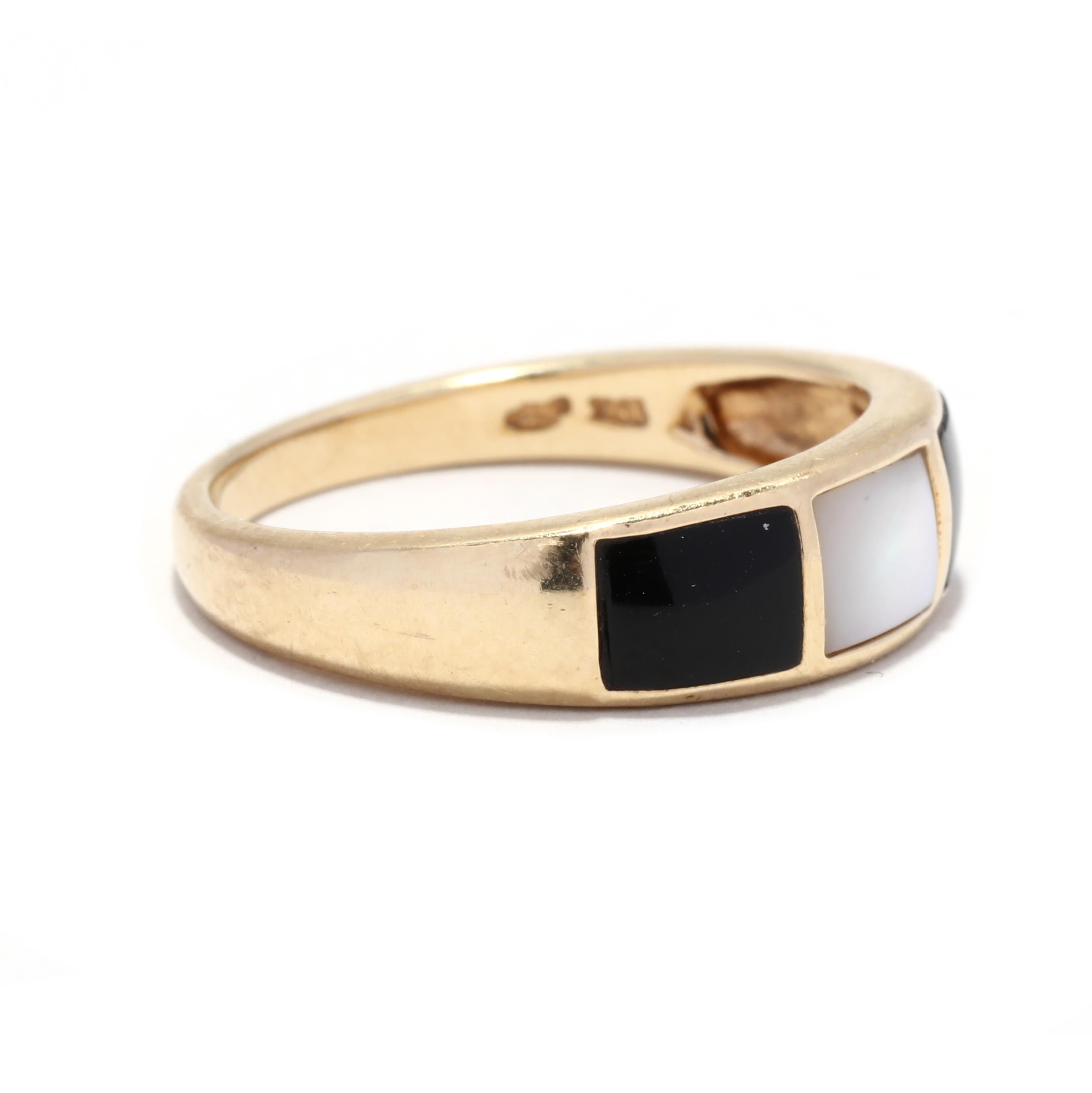 A vintage 14 karat yellow god black onyx and mother of pearl ring. This gold stackable band ring features rectangular tablets on inlaid black onyx and mother of pearl with a tapered band.

Stones:
- black onyx, 2 stones
- cushion tablet

- mother of