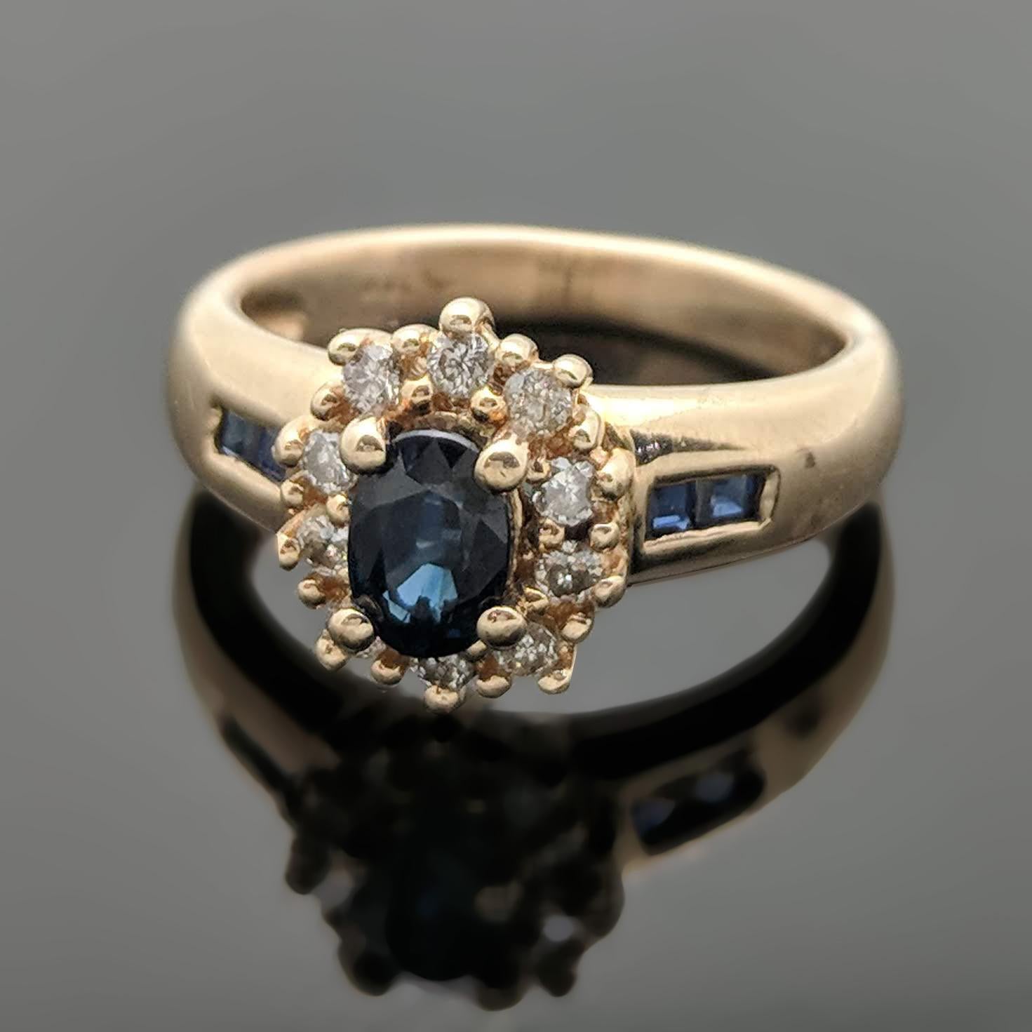 A vintage 14kt yellow gold ring featuring a center oval blue sapphire with an estimated weight of 0.58ct, side sapphires at an estimated 0.12 cttw and round brilliant-cut diamonds at an estimated 0.10 cttw. Estimated weight of gold is 3.5 gr. 

We