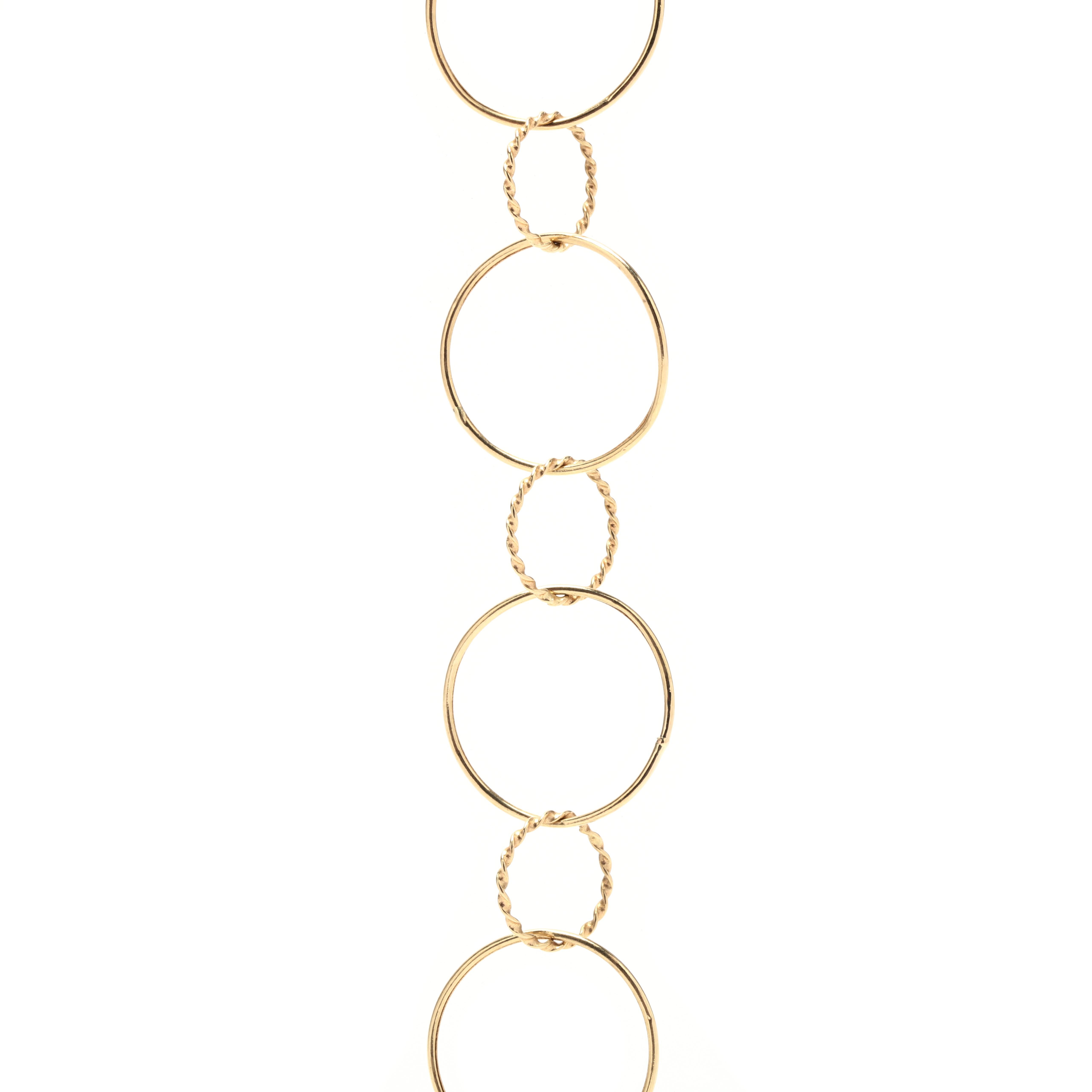 A vintage 14 karat yellow gold multi circle chain necklace. This long layering chain features alternating large polished circle links with small twist circle links and finished with a lobster clasp.

Length: 37 in.

Width: 3/4 in.

Weight: 8.6 dwts.