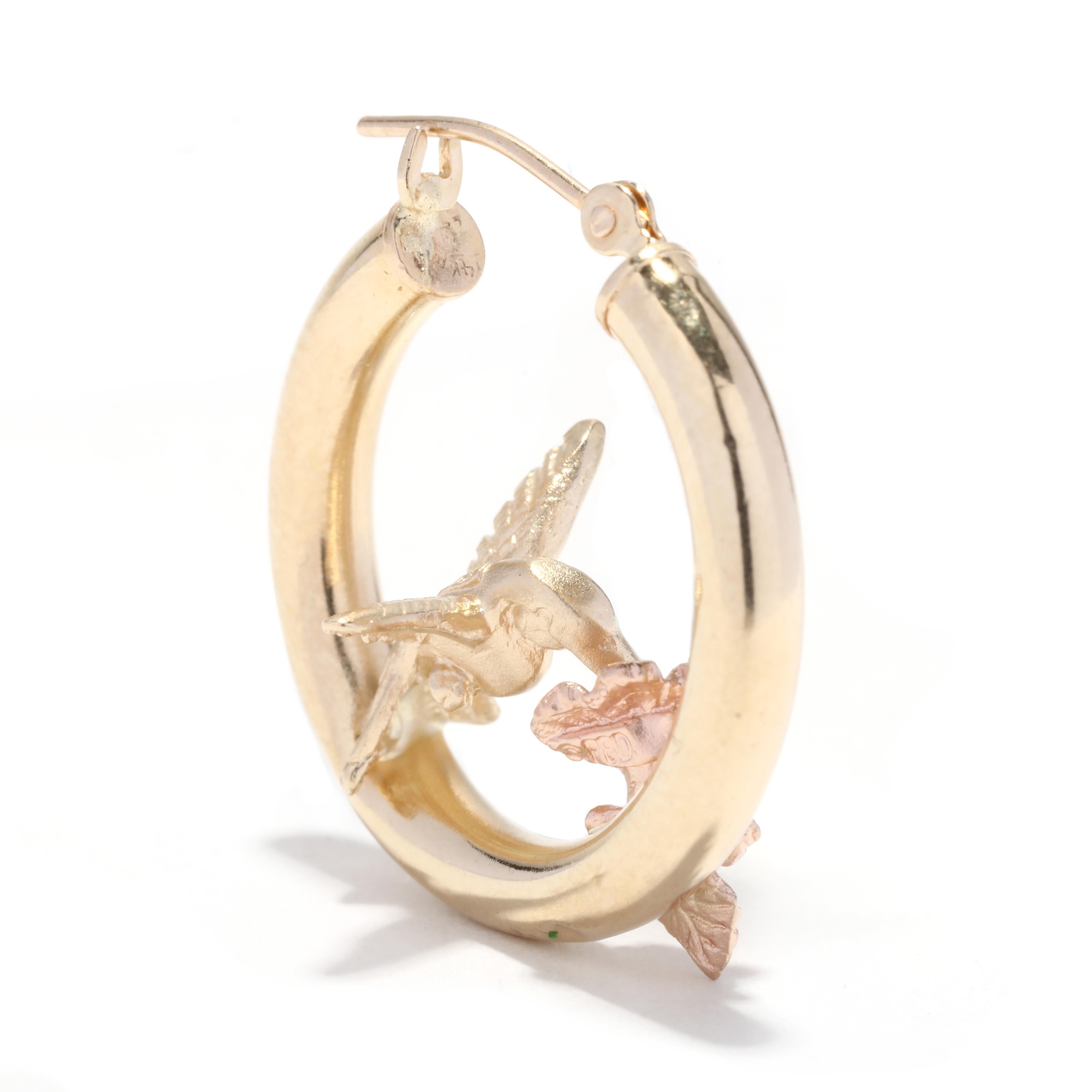 A vintage 14 karat yellow rose gold hummingbird hoop earrings. These earrings feature small tube hoops with 3D hummingbird sitting atop and with a floral detail.

Length: 7/8 in.

Tube Width: 3 mm

Weight: 2.5 dwts. / 3.89 grams

Stamps: 14K


Ring