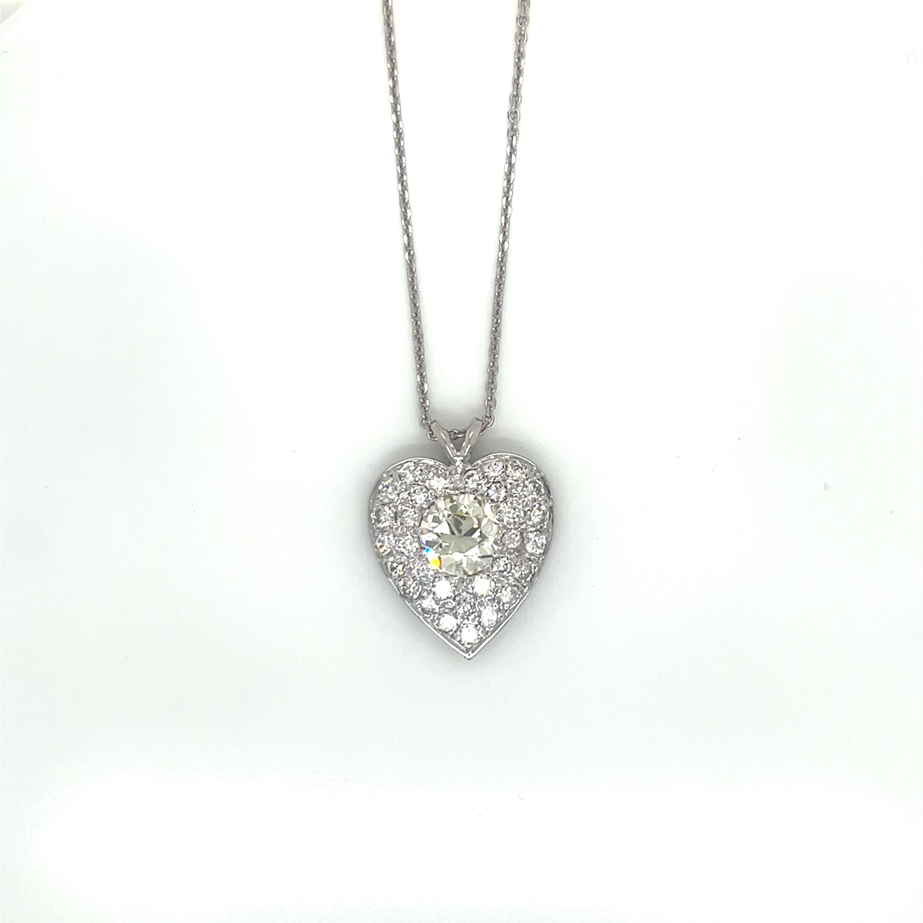 Vintage 14K White Gold Diamond Heart Pendant Necklace

This exquisite handmade vintage heart pendant necklace showcases remarkable craftsmanship. The centerpiece of this stunning jewel is a magnificent old European cut diamond weighing approximately
