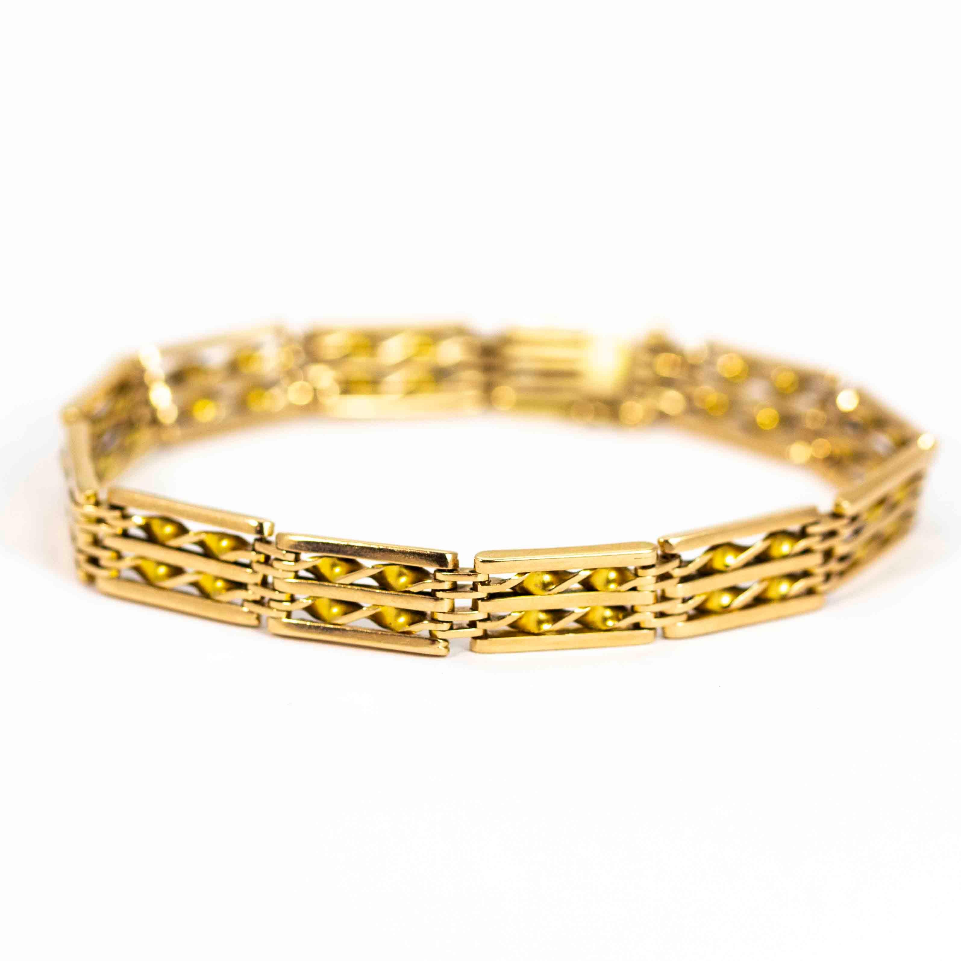 An exquisite vintage gate bracelet. Each chunky link is composed of five bars, with the central two elegantly twisted for contrast. Modelled in 15 carat yellow gold.

Length: 7.5 inches