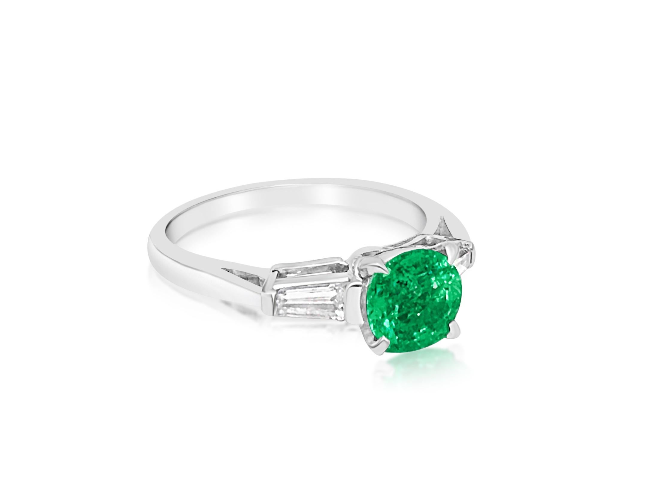 Metal: Platinum 900. 
1.50 carat emerald. Round shape emerald set in prongs. Excellent saturation and color. 
0.30cts diamonds total. VVS clarity and F color. Baguette cut. 
Total carat weight of all precious stones: 1.80cts. 
All stones are 100%