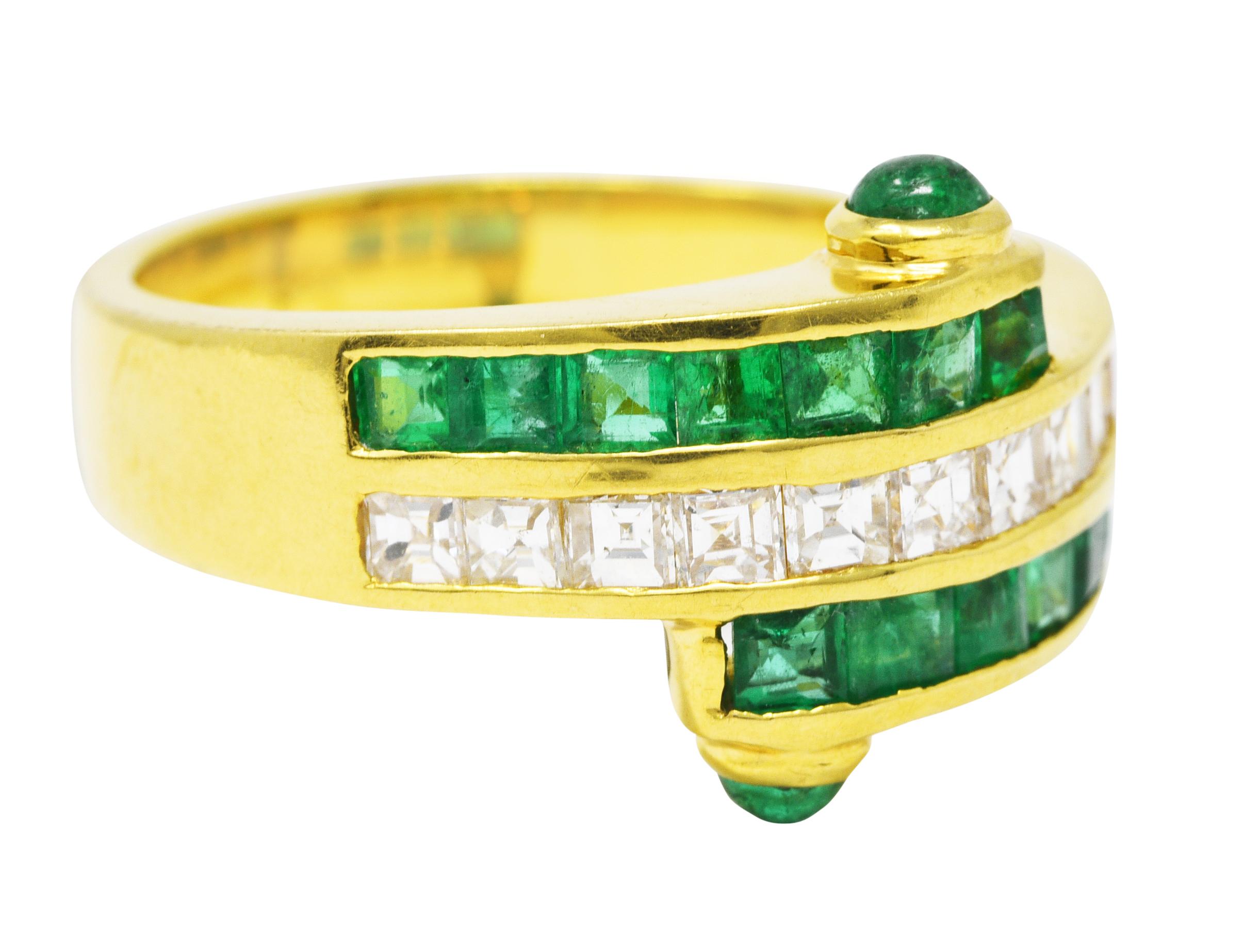 Bypass ring is comprised of three adjacent channels. Central row features square step cut diamonds. Weighing in total approximately 0.50 carat - G/H color with VS clarity. Remaining channels feature square cut emeralds with emerald cabochon