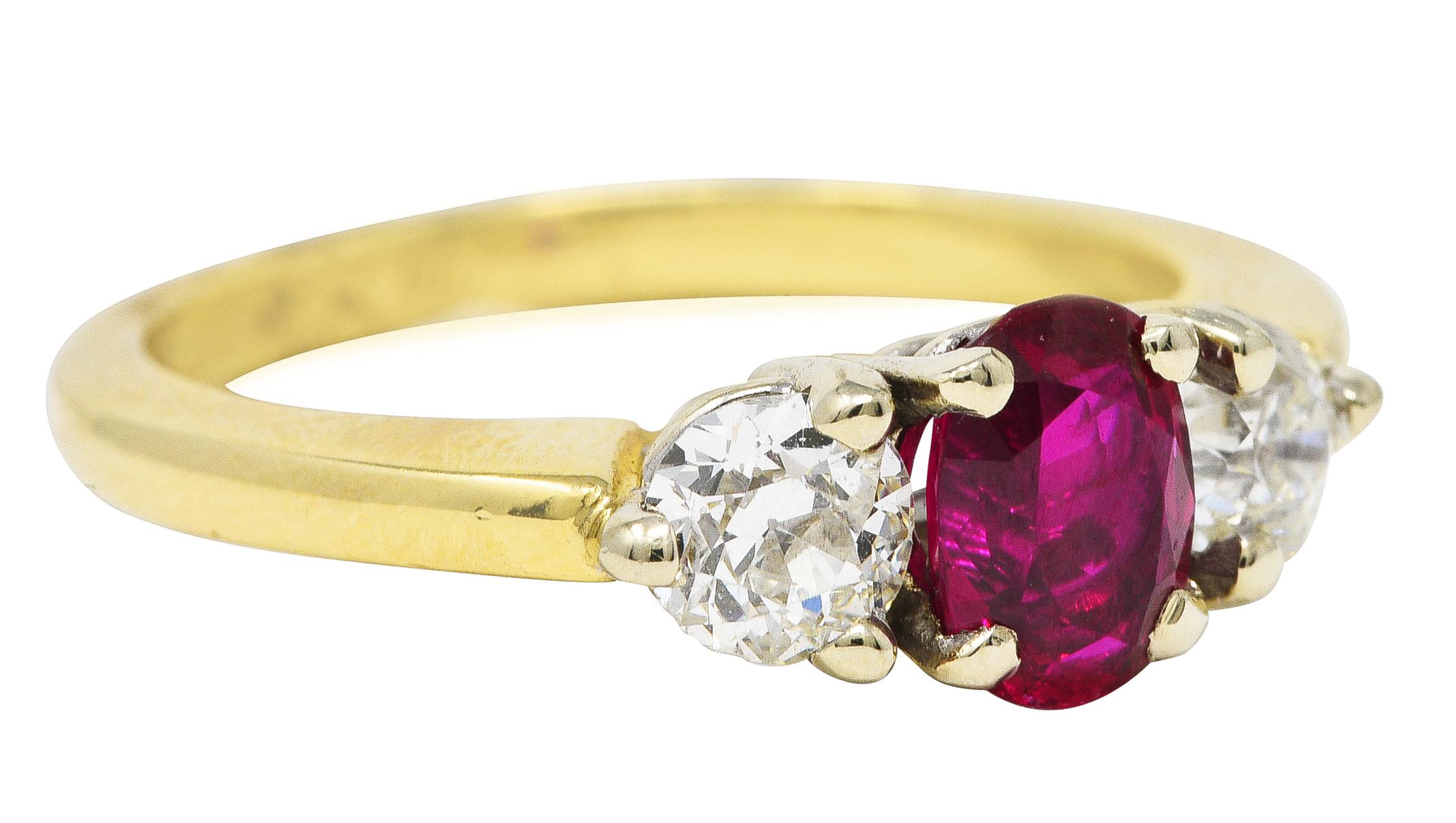 Featuring an oval cut ruby weighing approximately 0.85 carat. Eye clean and pinkish red in color - medium in saturation. Basket set in white gold and flanked by two old European cut diamonds. Weighing collectively approximately 0.65 carat - I/J
